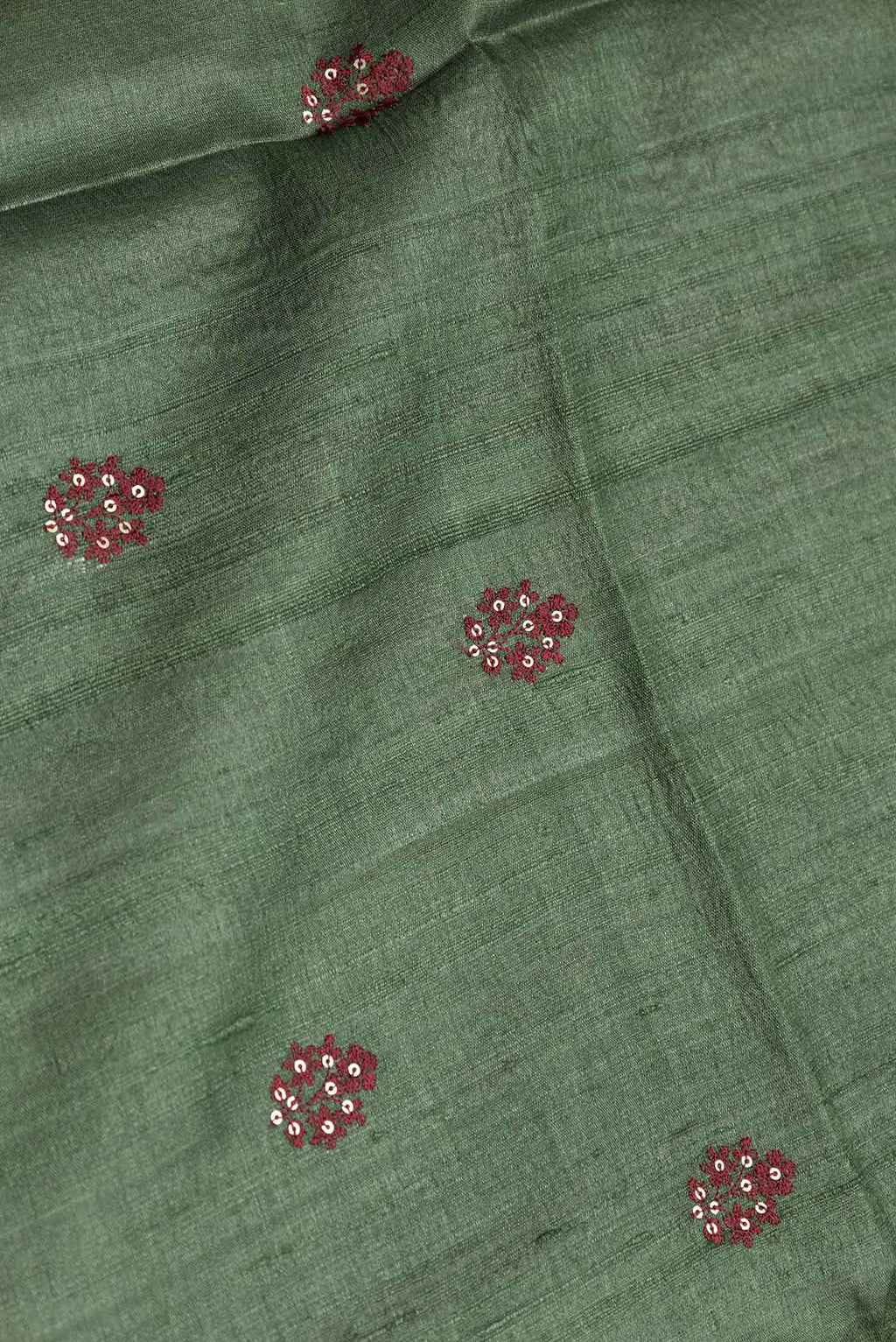 Close up of Bottle Green Dual Tone Tussar Silk Saree with Embroidery on the body and Printed Border displaying folds