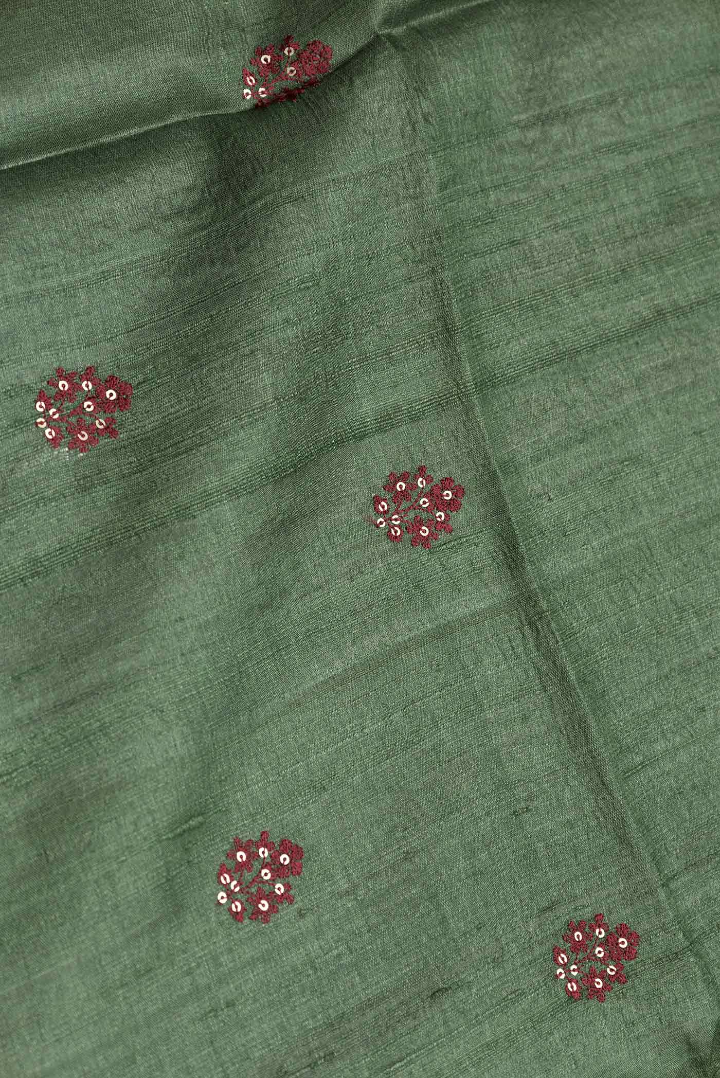 Close up of Bottle Green Dual Tone Tussar Silk Saree with Embroidery on the body and Printed Border displaying folds