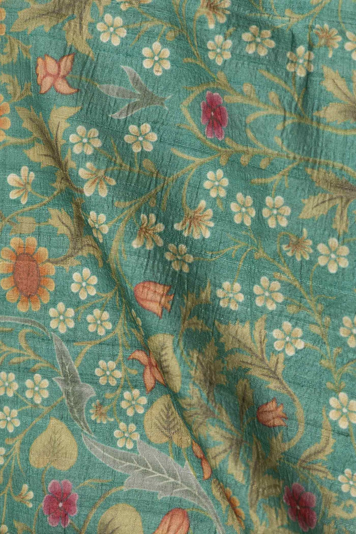Close up of Green Dual Tone Tussar Silk Saree with Printed design on the body and Printed Border displaying folds
