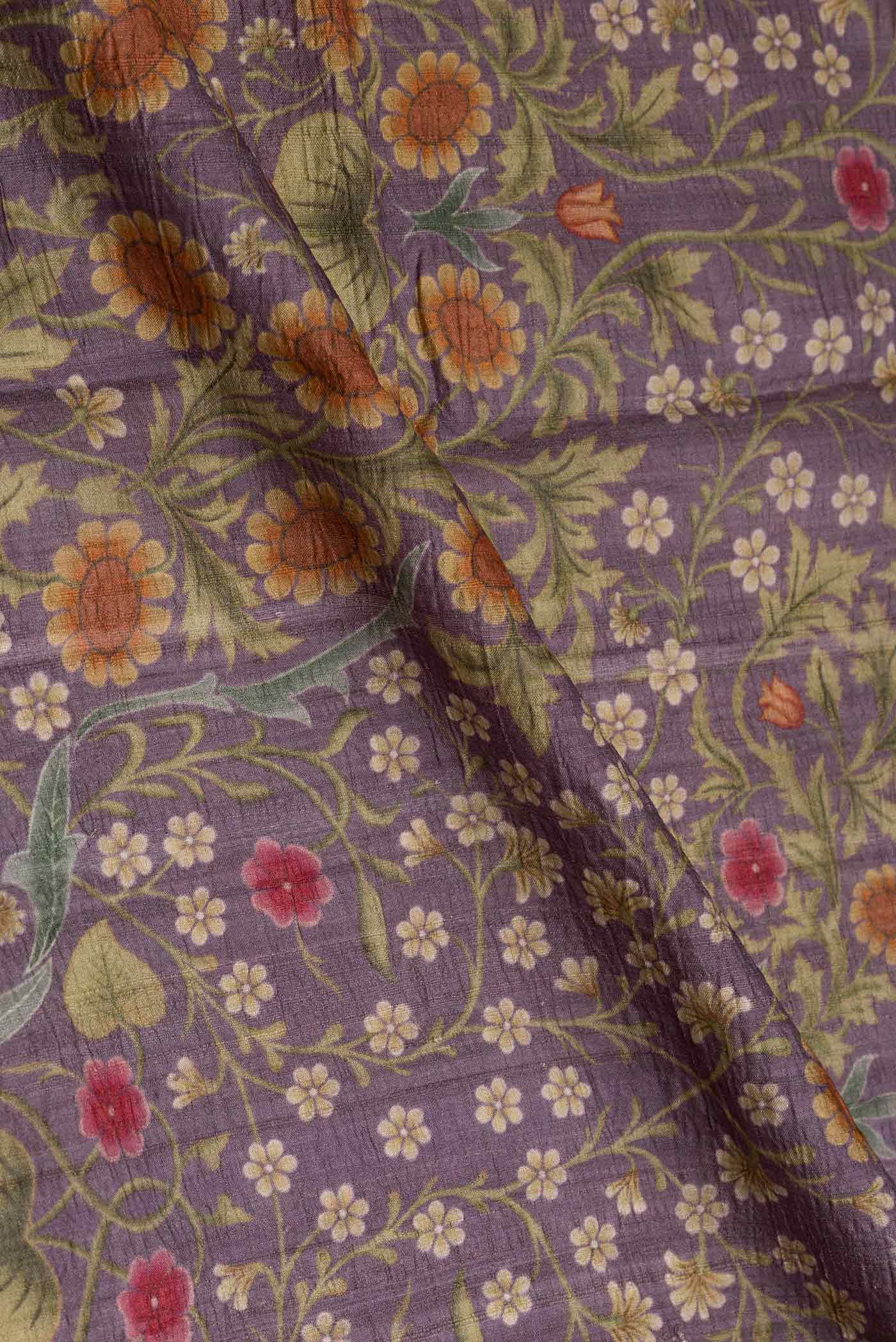 Close up of Lilac Tussar Silk Saree with Printed design on the body and Embroidery Border displaying folds