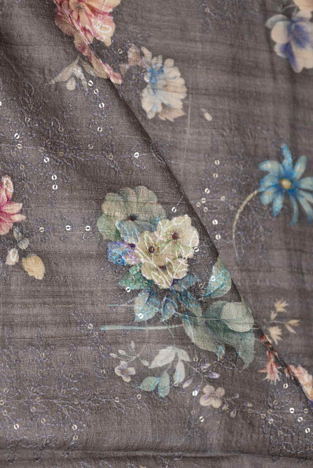 Close up of Grey Dual Tone Tussar Silk Saree with Printed design on the body and Printed Border displaying folds
