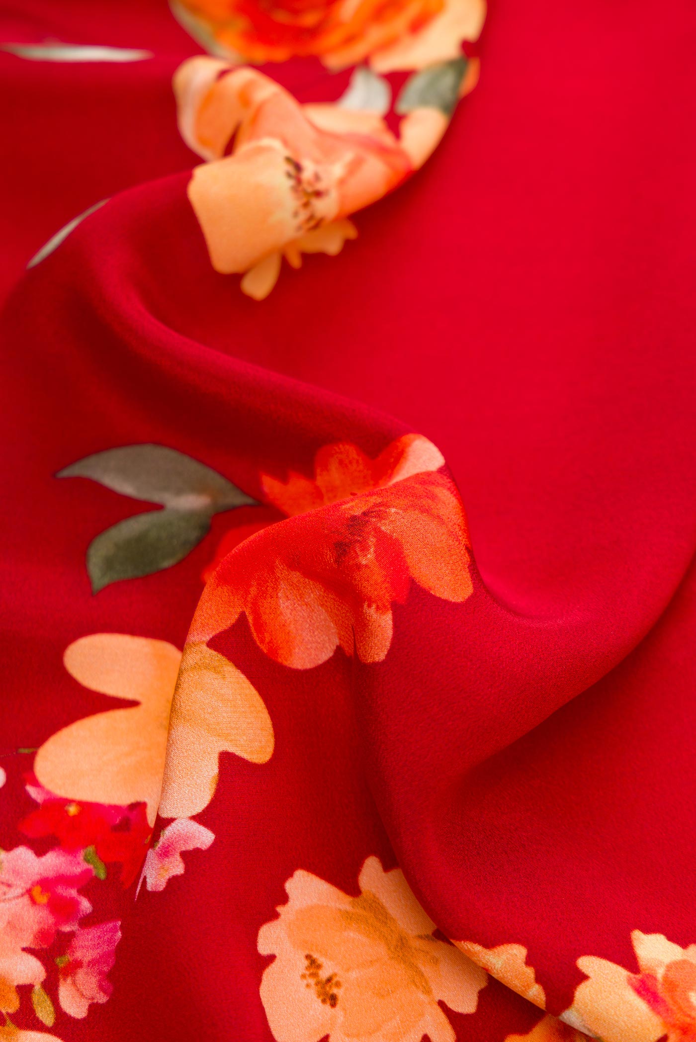 Close up of Red Dual Tone Mysore Crepe Saree with Printed design on the body and Without Border.  displaying folds