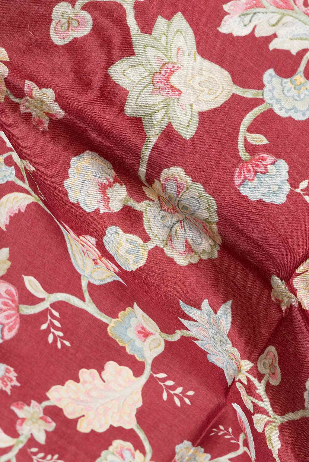 Close up of Maroon Dual Tone Tussar Silk Saree with Printed design on the body and Printed Border.  displaying folds