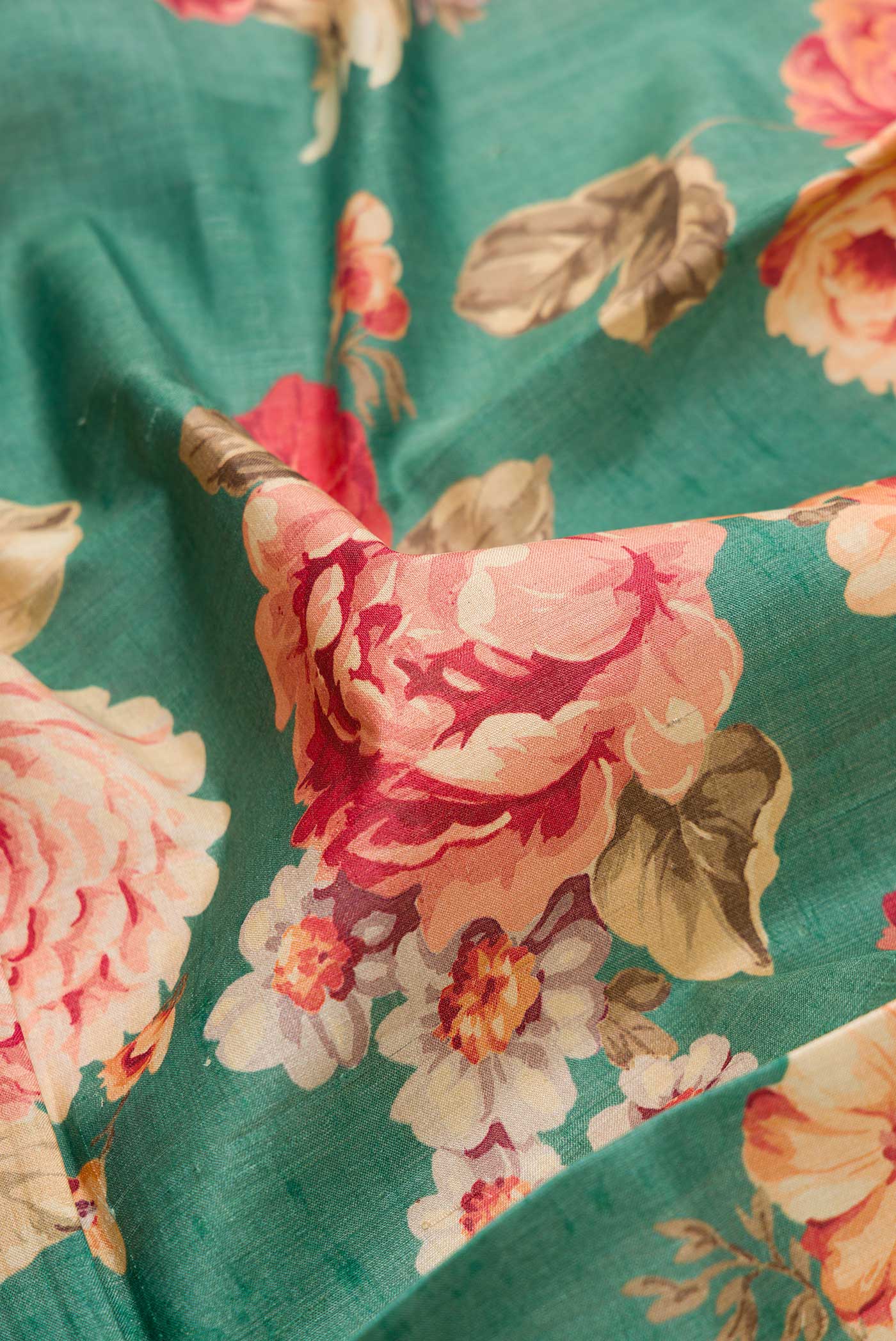 Close up of Green Dual Tone Tussar Silk Saree with Printed design on the body and Zari Border.  displaying folds