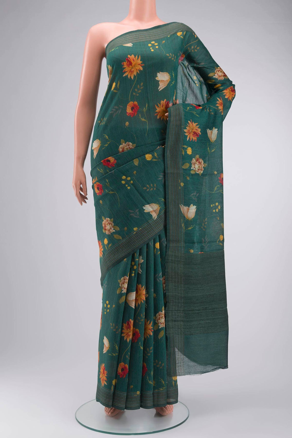 Green Tussar Silk Saree with Printed design on the body and Zari Border displayed on a mannequin