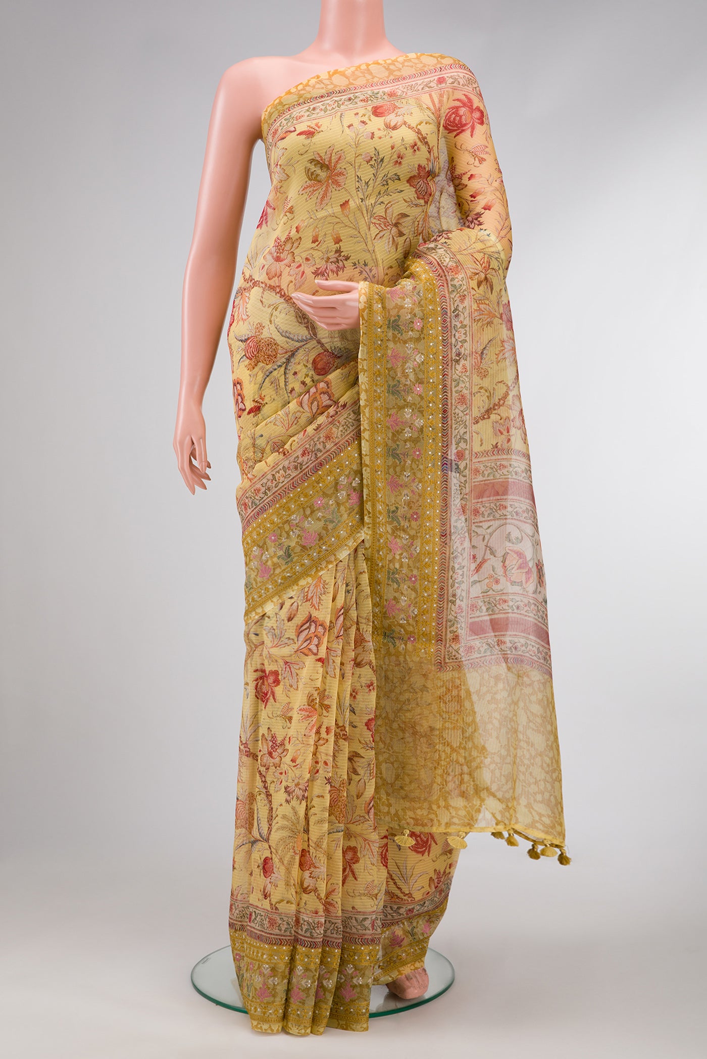 Mustard Dual Tone Organza Silk Saree with Printed design on the body and Embroidery Border.  displayed on a mannequin
