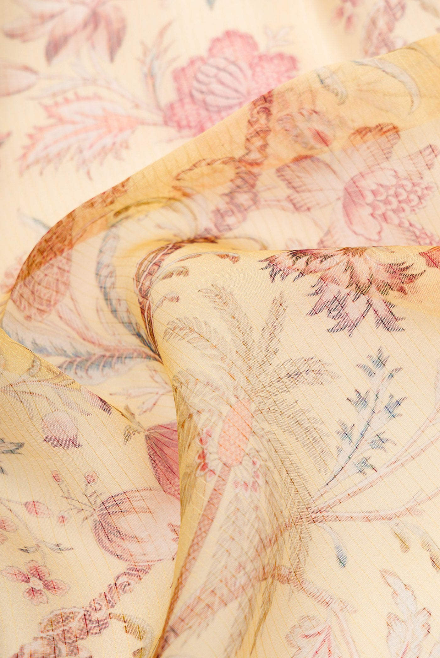 Close up of Mustard Dual Tone Organza Silk Saree with Printed design on the body and Embroidery Border.  displaying folds