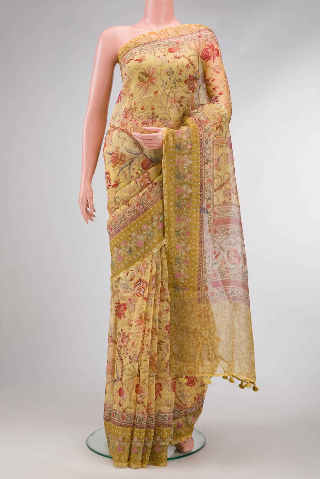 Mustard Dual Tone Organza Silk Saree with Printed design on the body and Embroidery Border.  displayed on a mannequin