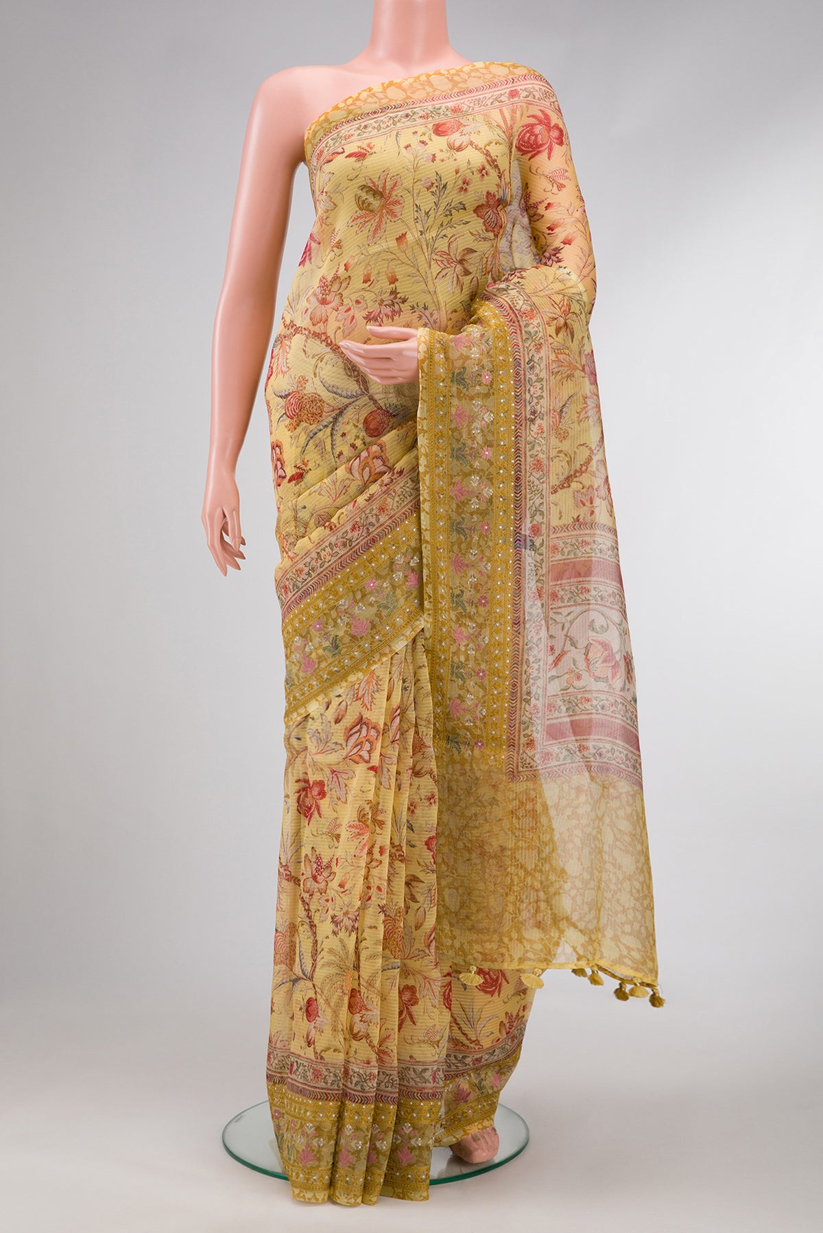 Mustard Dual Tone Organza Silk Saree with Printed design on the body and Embroidery Border.  displayed on a mannequin