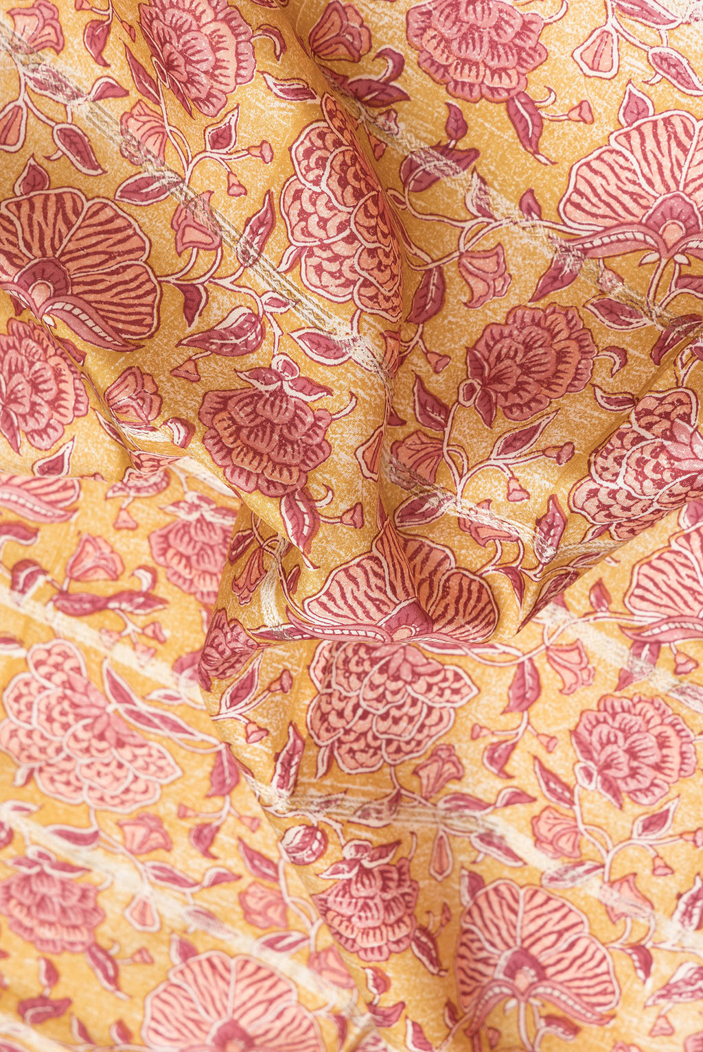Close up of Yellow Dual Tone Kanchipuram Silk Saree with Printed design on the body and Zari Border.  displaying folds