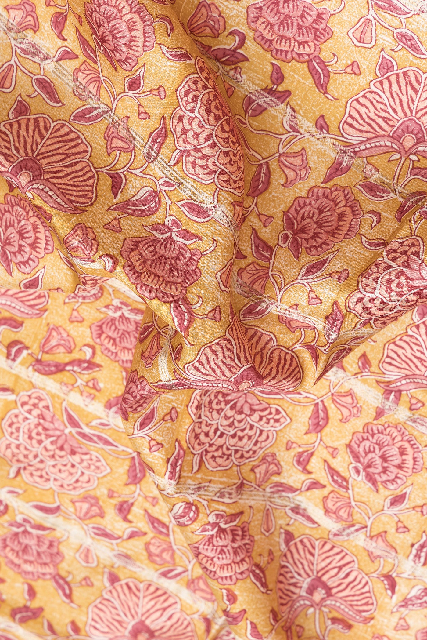 Close up of Yellow Dual Tone Kanchipuram Silk Saree with Printed design on the body and Zari Border.  displaying folds