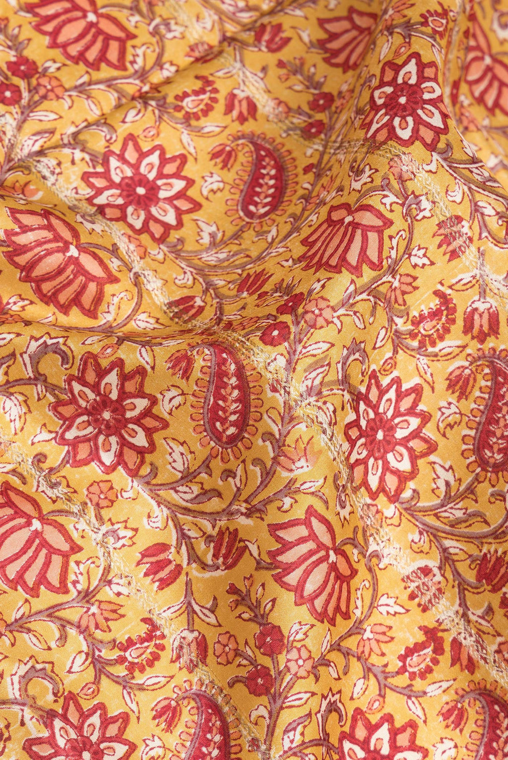 Close up of Pure Silk Mustard Kanchipuram Saree with Printed design on the body and Zari Border.  displaying folds
