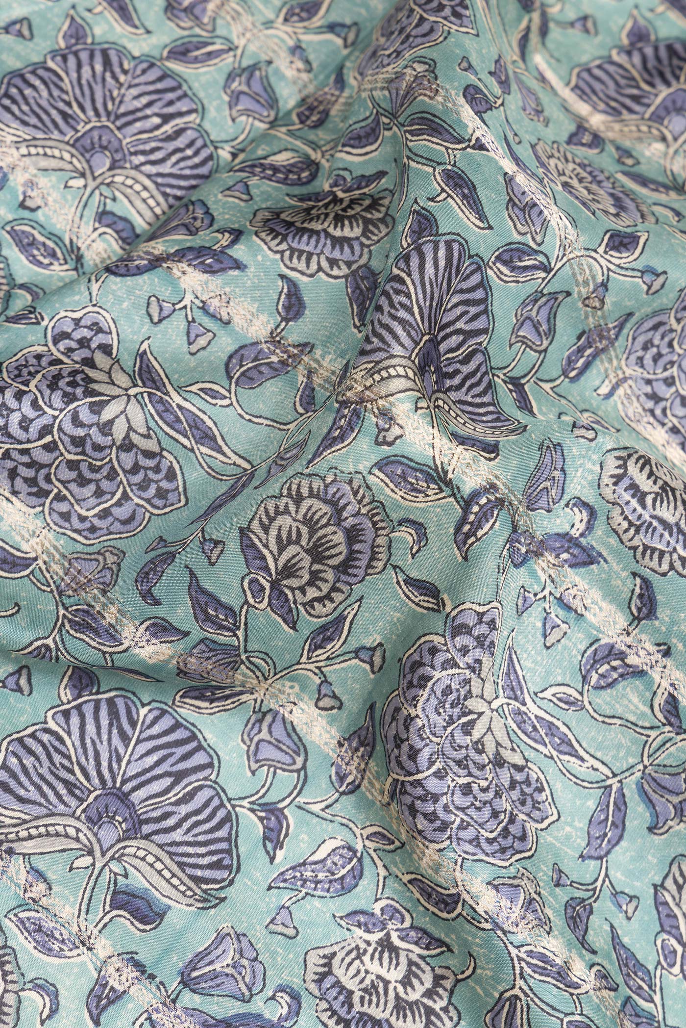 Close up of Pure Silk Light Blue Kanchipuram Saree with Printed design on the body and Zari Border.  displaying folds