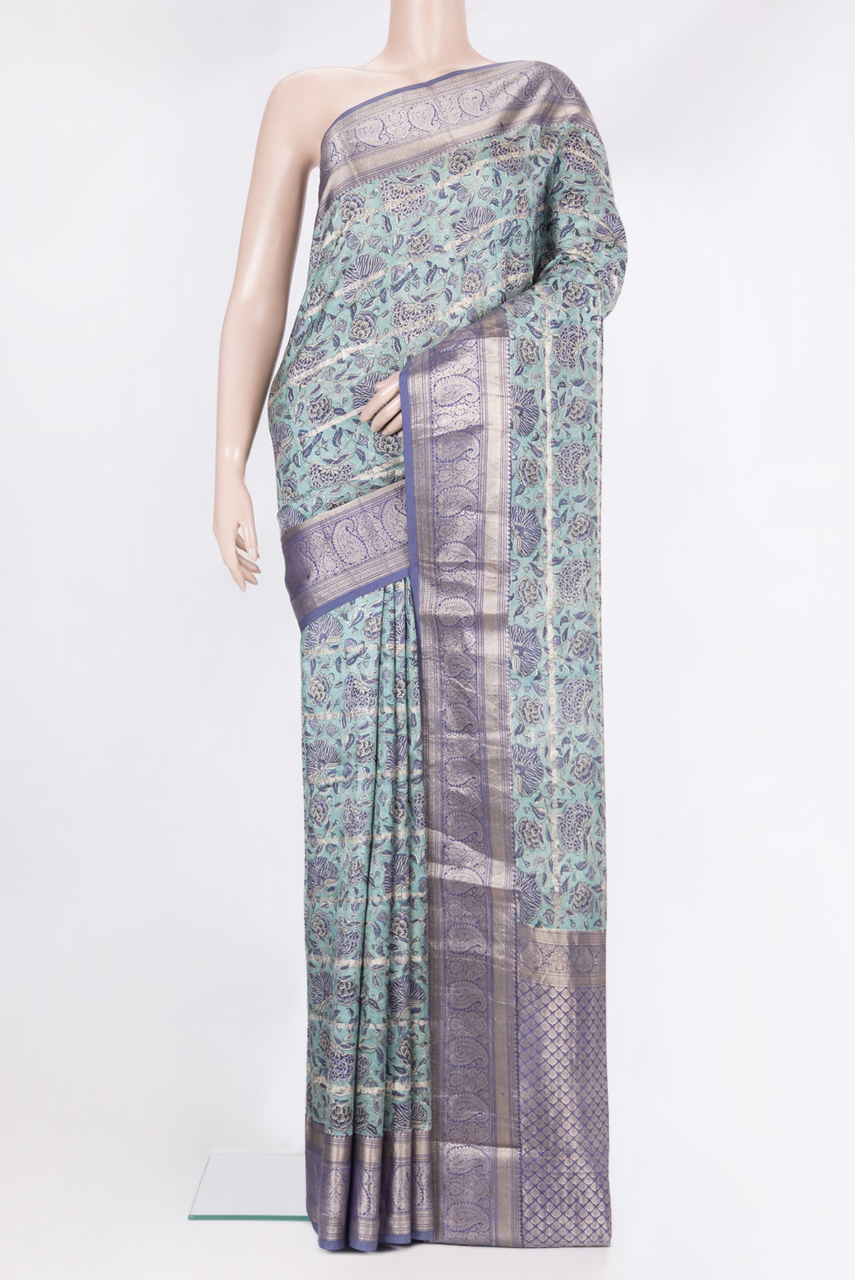 Pure Silk Light Blue Kanchipuram Saree with Printed design on the body and Zari Border.  displayed on a mannequin