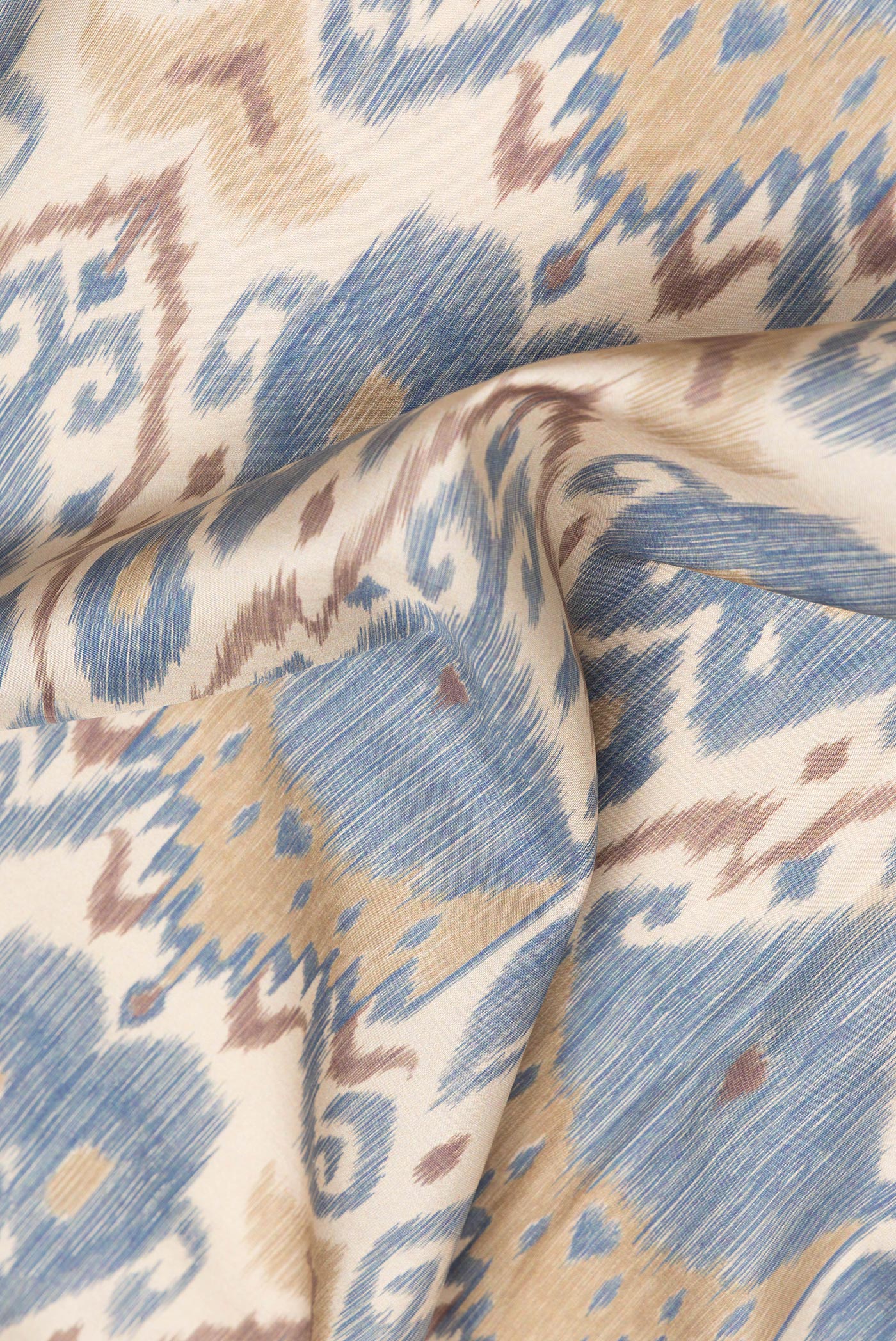 Close up of Dark Beige Dual Tone Kanchipuram Silk Saree with Ikat Print on the body and Zari Border.  displaying folds
