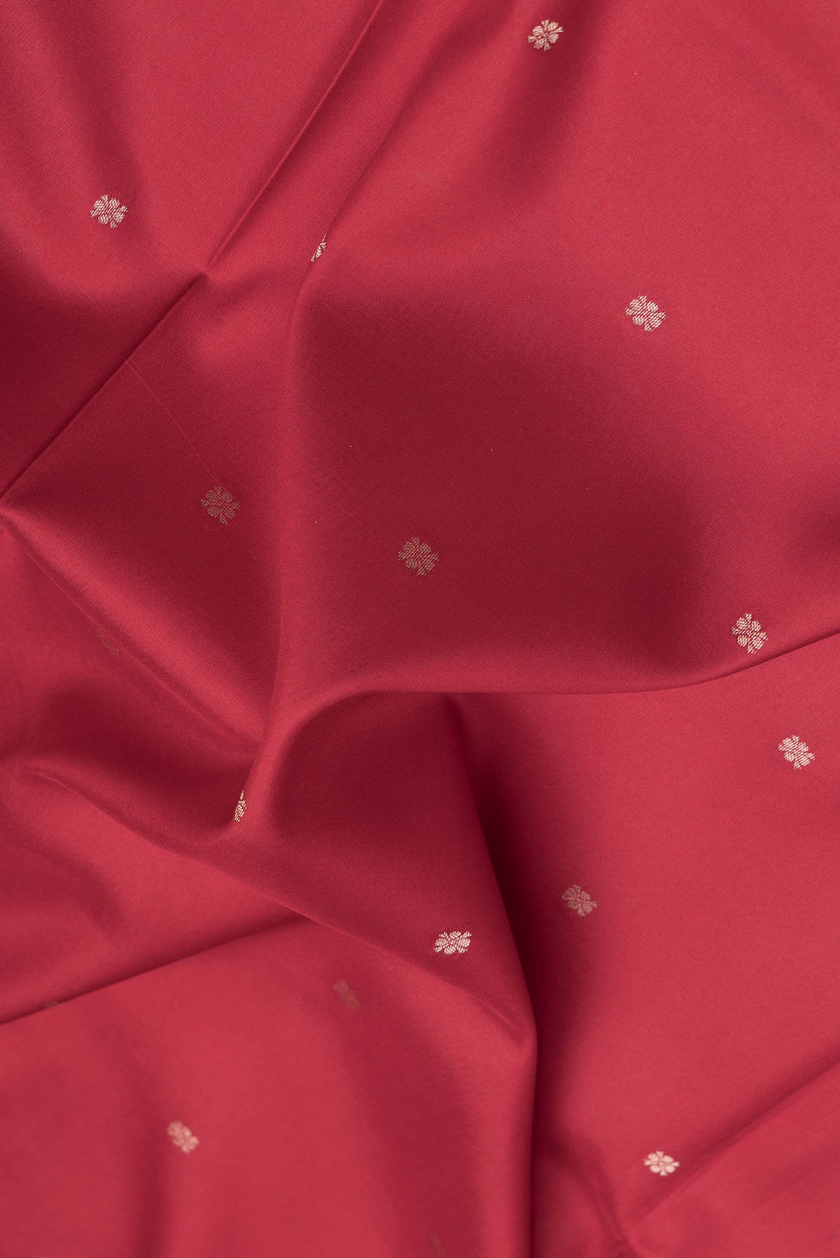 Close up of Red Dual Tone Kanchipuram Silk Saree with Zari Butta on the body and Fancy Border.  displaying folds