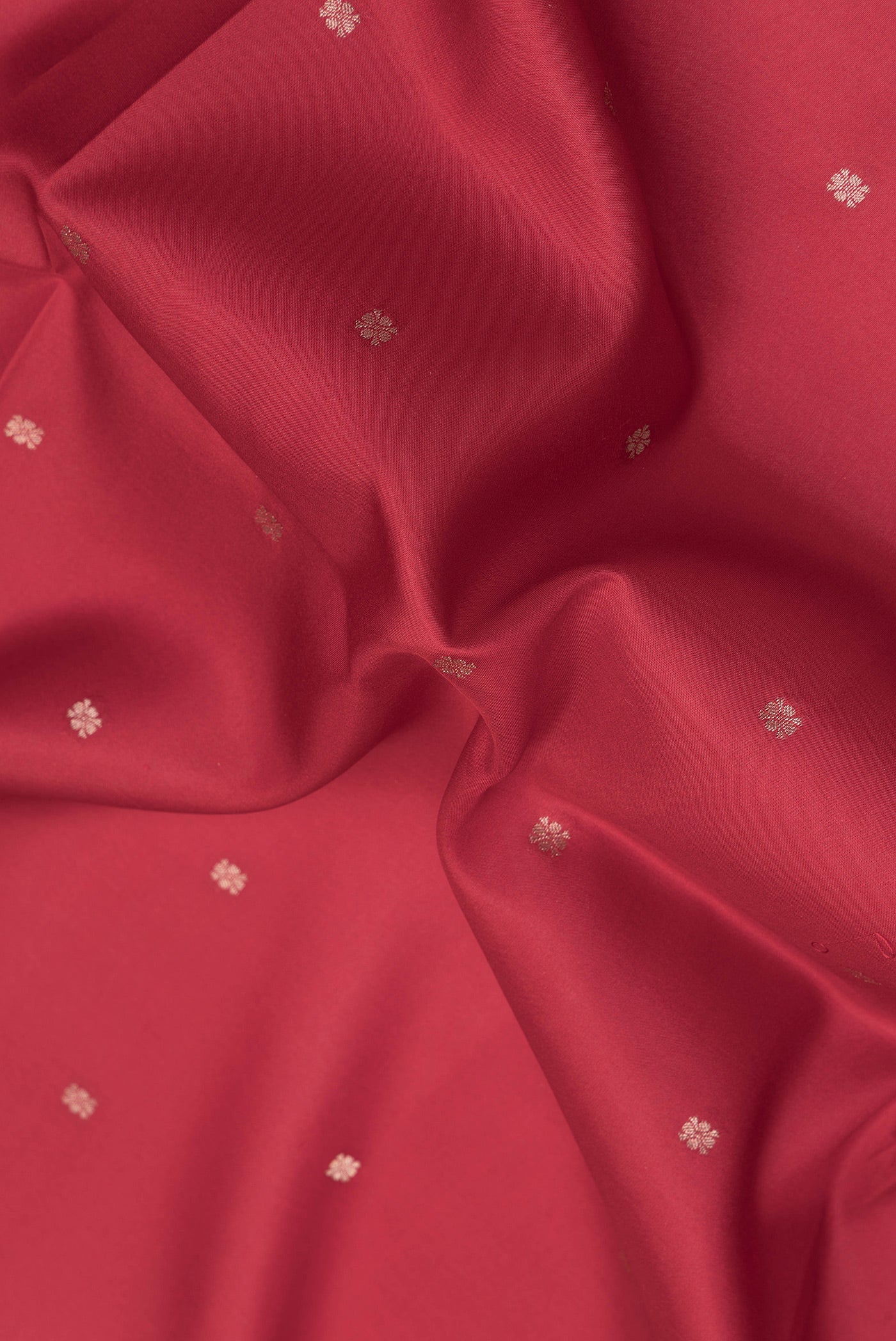 Close up of Red Dual Tone Kanchipuram Silk Saree with Zari Butta on the body and Fancy Border.  displaying folds