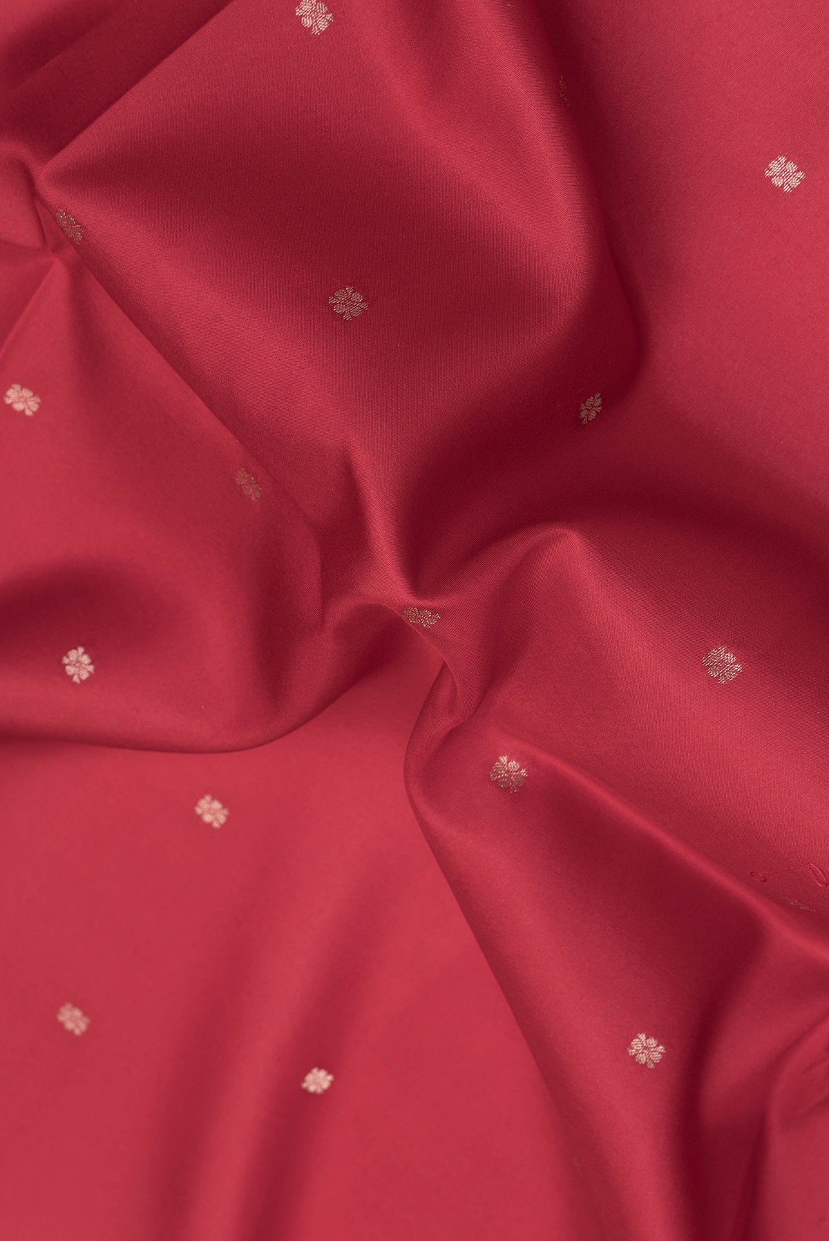 Close up of Red Dual Tone Kanchipuram Silk Saree with Zari Butta on the body and Fancy Border.  displaying folds