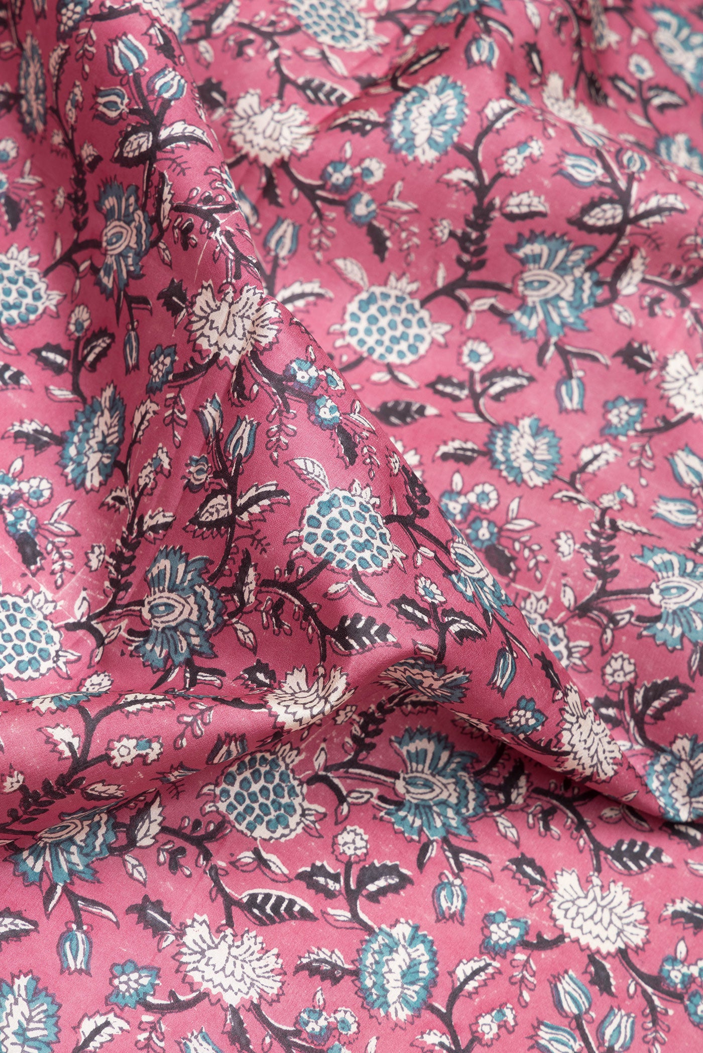 Close up of Pink Dual Tone Kanchipuram Silk Saree with Printed design on the body and Zari Border.  displaying folds