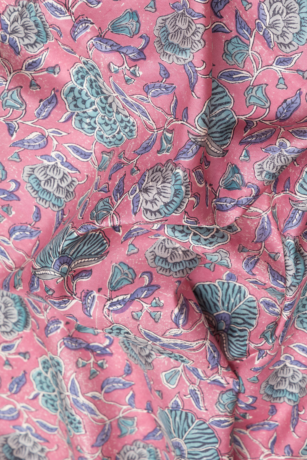 Close up of Pink Printed Silk Saree with Printed design on the body and Zari Border.  displaying folds