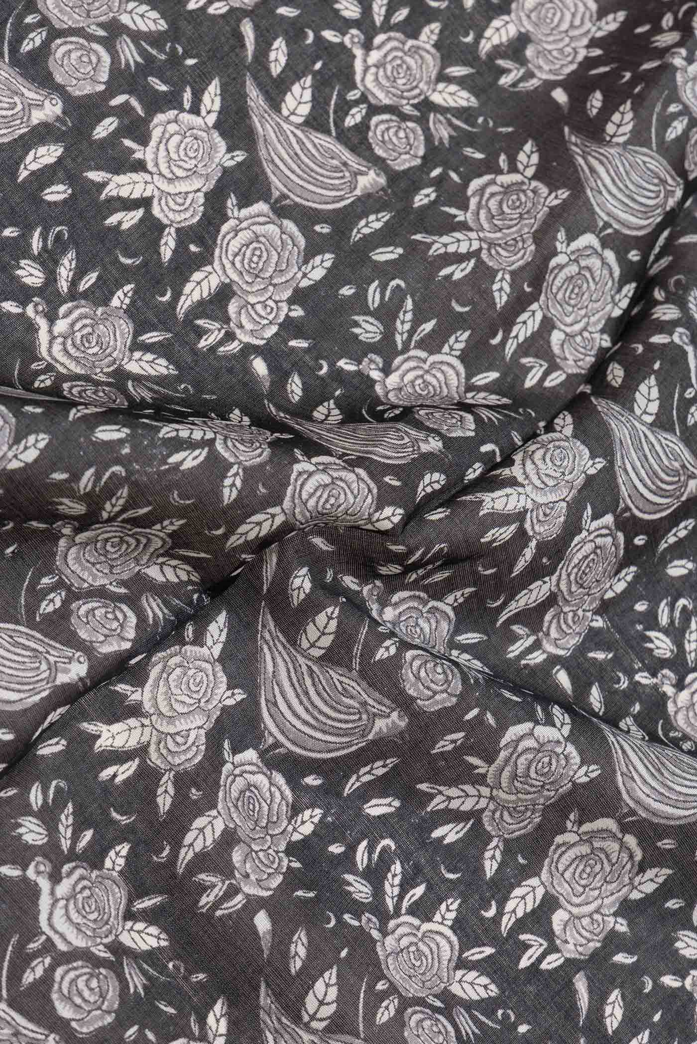 Close up of Black Dual Tone Tussar Silk Saree with Printed design on the body and Embroidery Border.  displaying folds