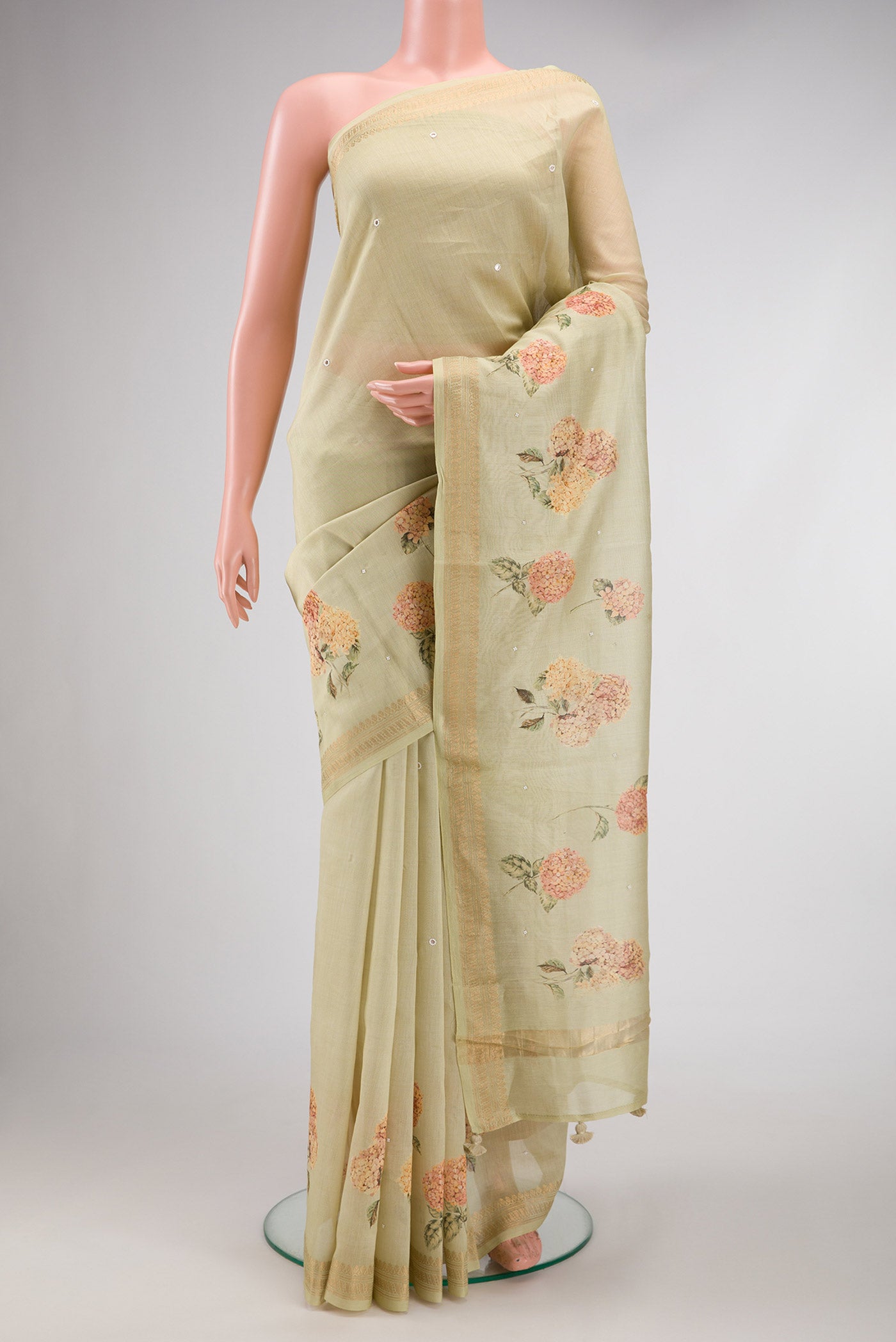 Pista Green Dual Tone Tussar Silk Saree with Printed design on the body and Zari Border.  displayed on a mannequin