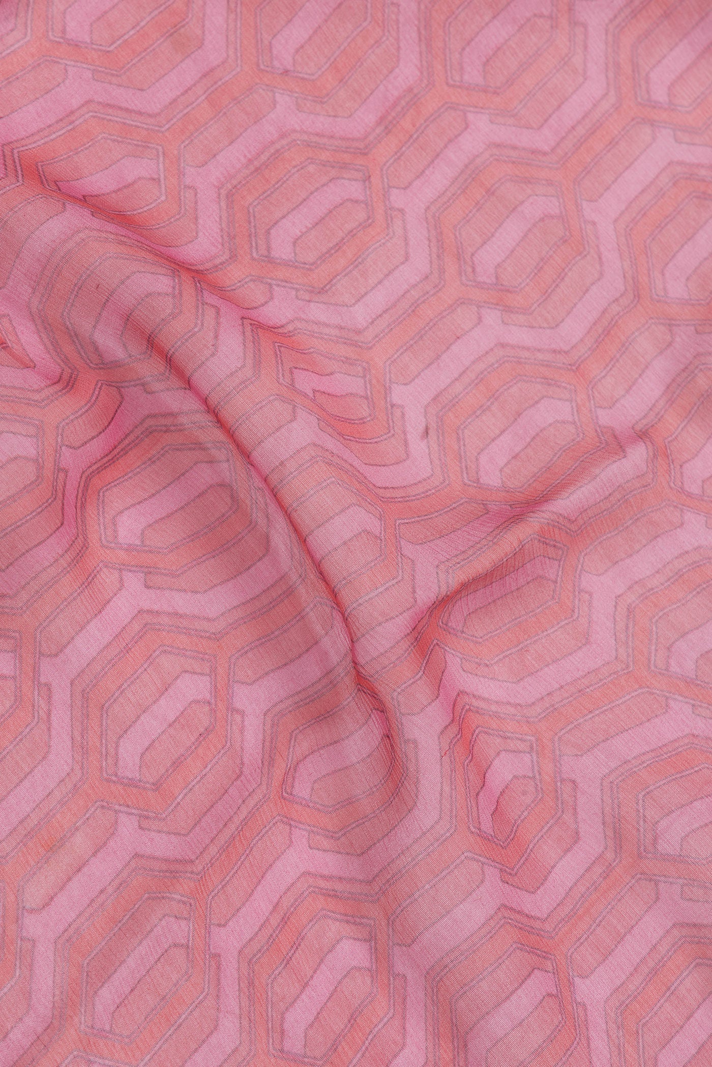 Close up of Pink Dual Tone Mysore Georgette Saree with Printed design on the body and Zari Border.  displaying folds