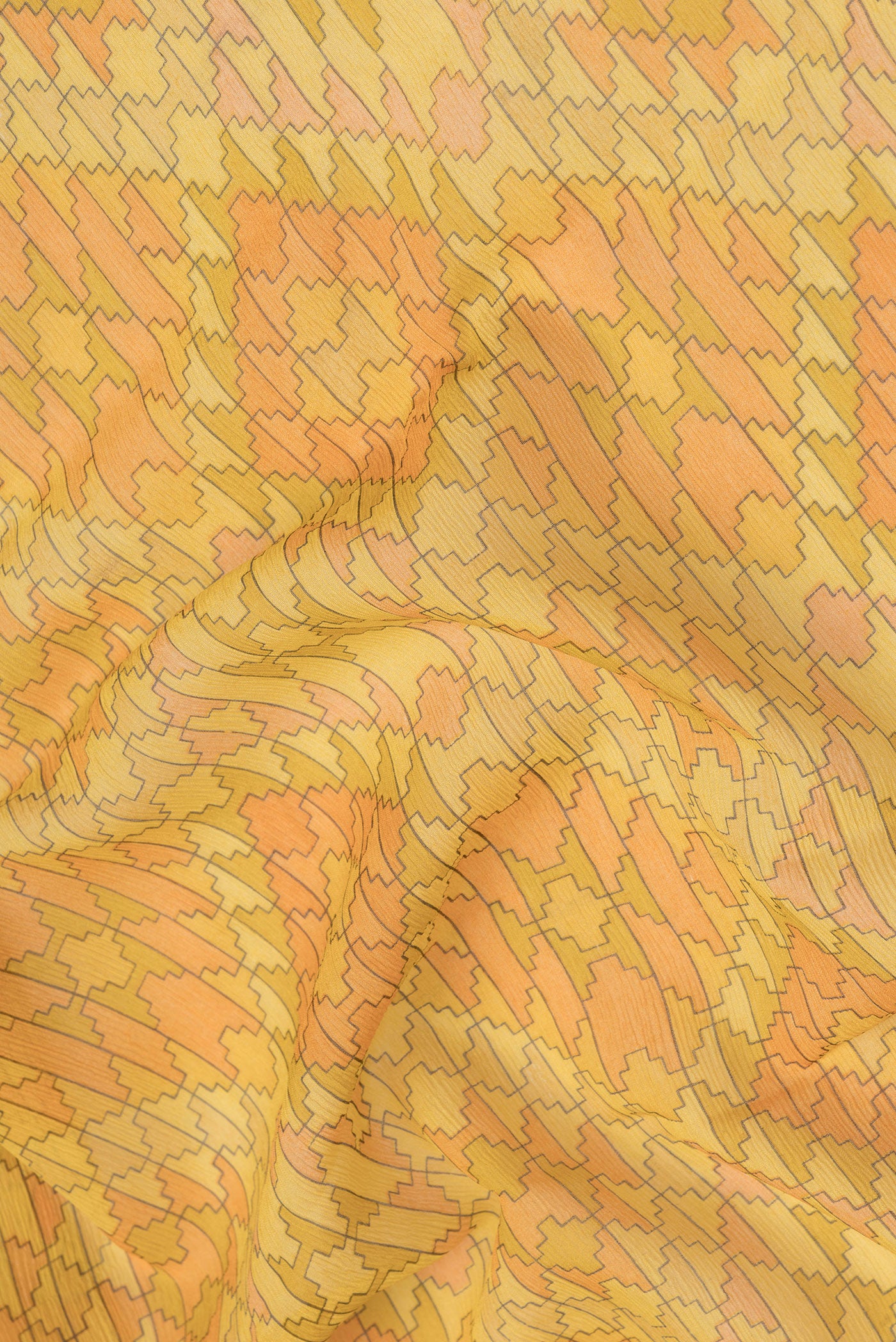 Close up of Yellow Mysore Chiffon Saree with Printed design on the body and Zari Border.  displaying folds