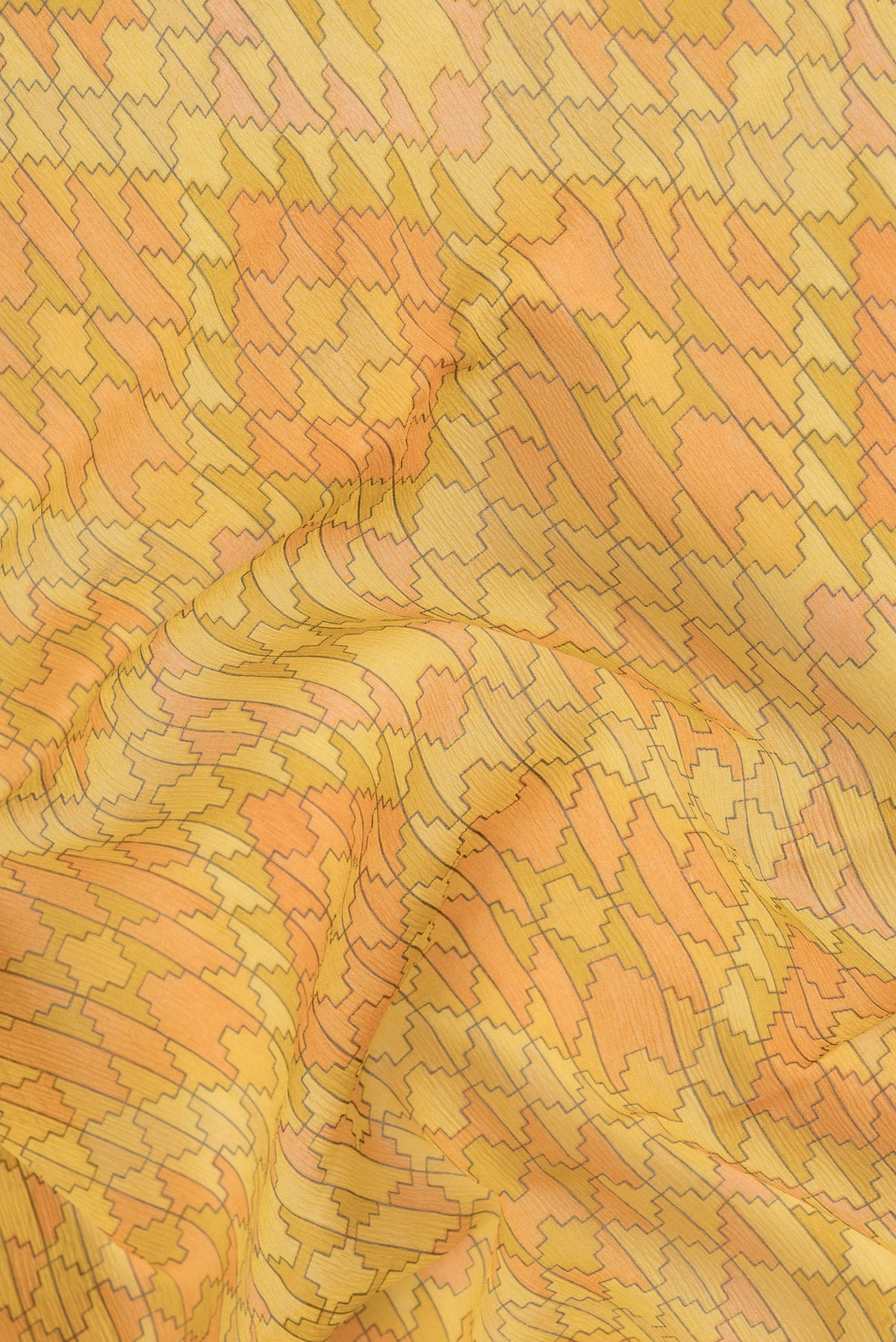 Close up of Yellow Mysore Chiffon Saree with Printed design on the body and Zari Border.  displaying folds