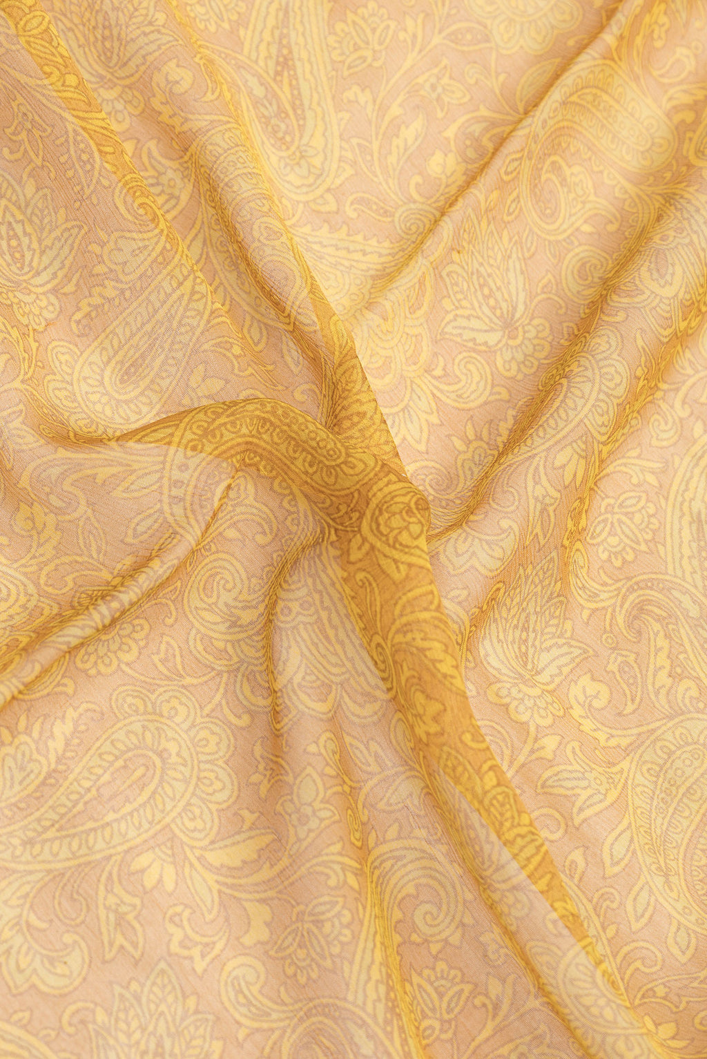 Close up of Mustard Dual Tone Mysore Chiffon Saree with Printed design on the body and Zari Border.  displaying folds