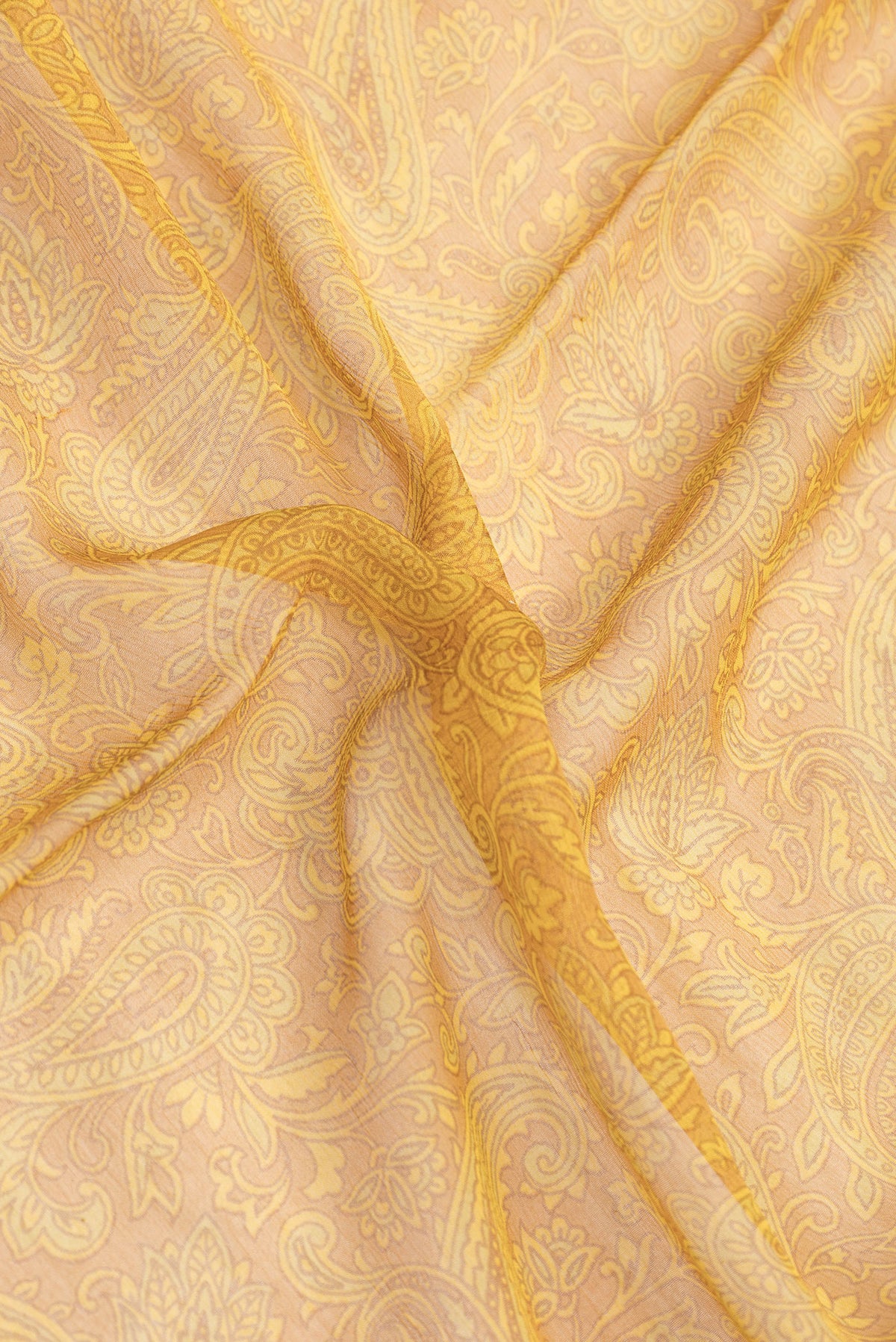 Close up of Mustard Dual Tone Mysore Chiffon Saree with Printed design on the body and Zari Border.  displaying folds