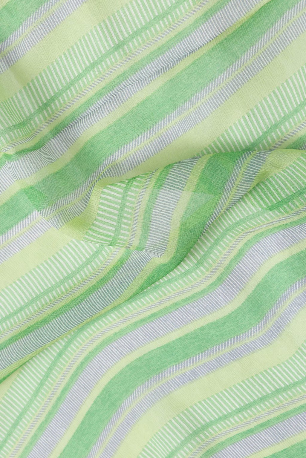 Close up of Parrot Green Dual Tone Mysore Chiffon Saree with Printed design on the body and Zari Border.  displaying folds
