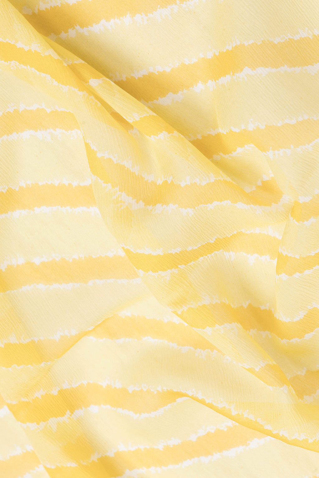 Close up of Yellow Dual Tone Chiffon Saree with Stripes on the body and Zari Border.  displaying folds
