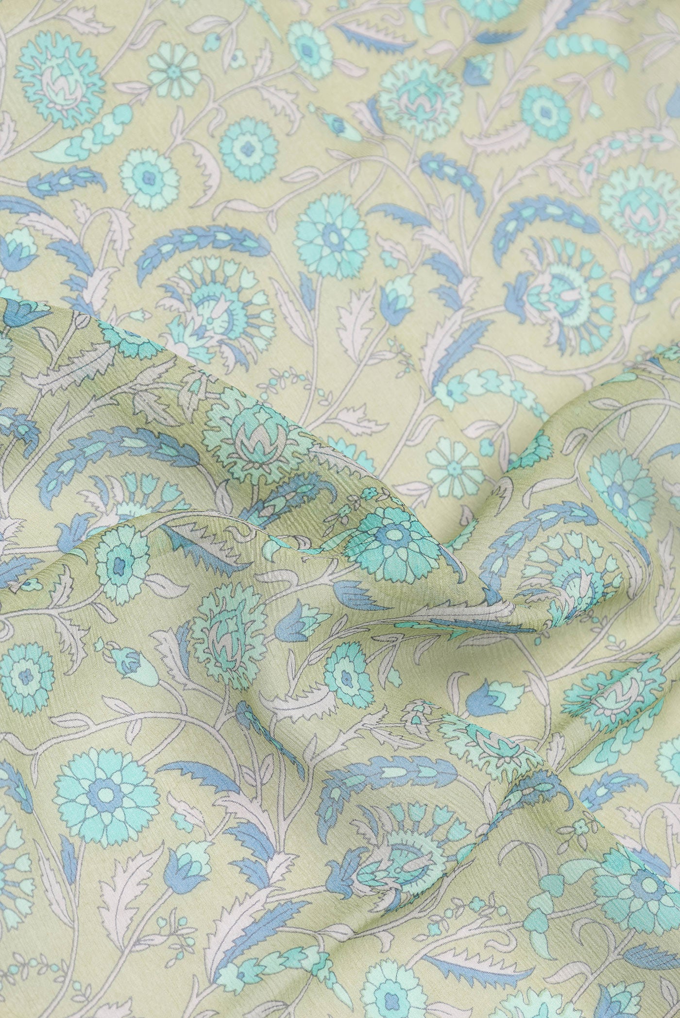 Close up of Pista Green Dual Tone Chiffon Nine Yards Saree with Printed design on the body and Zari Border.  displaying folds
