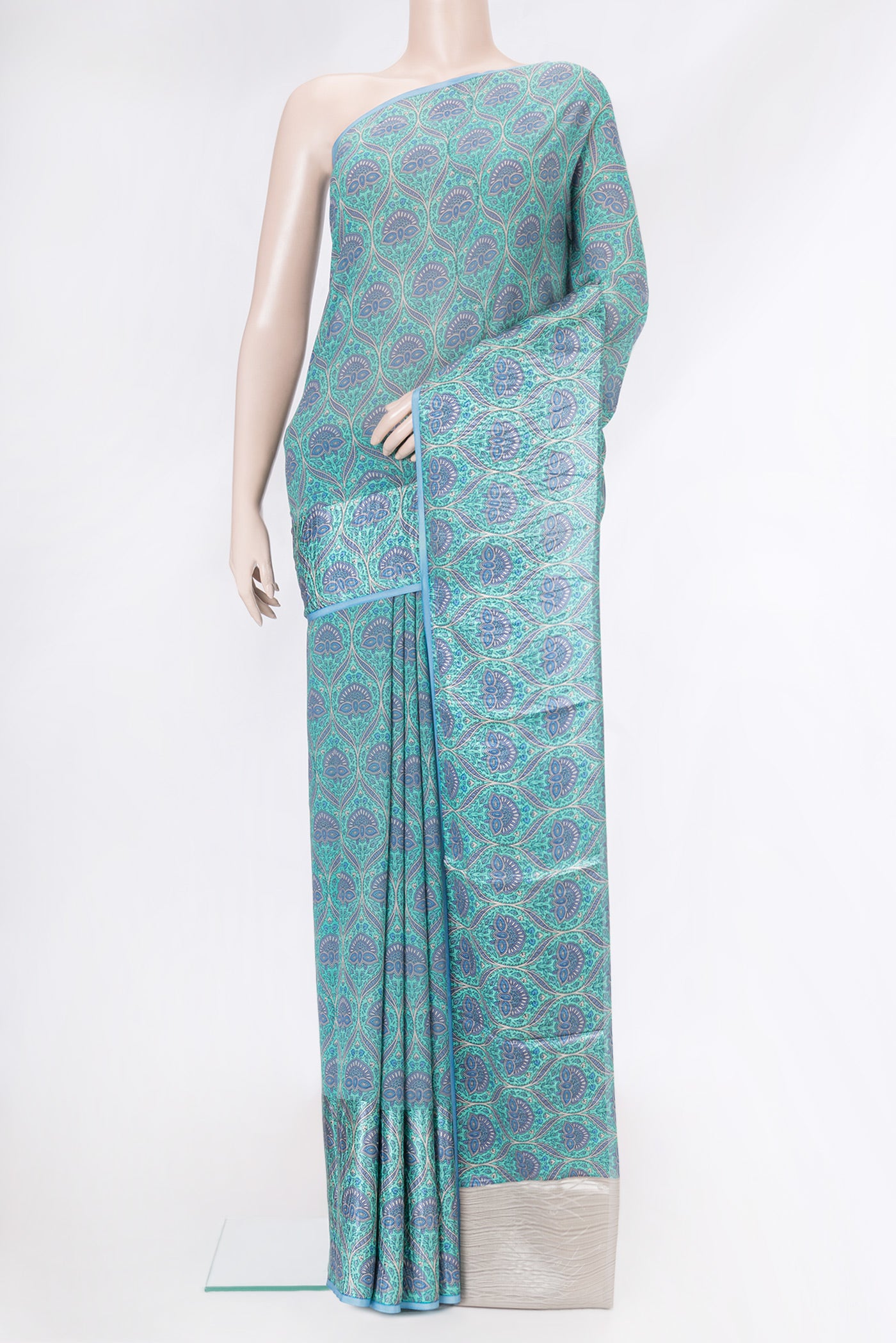 Sky Blue Dual Tone Mysore Crepe Saree with Printed design on the body and Plain Border.  displayed on a mannequin
