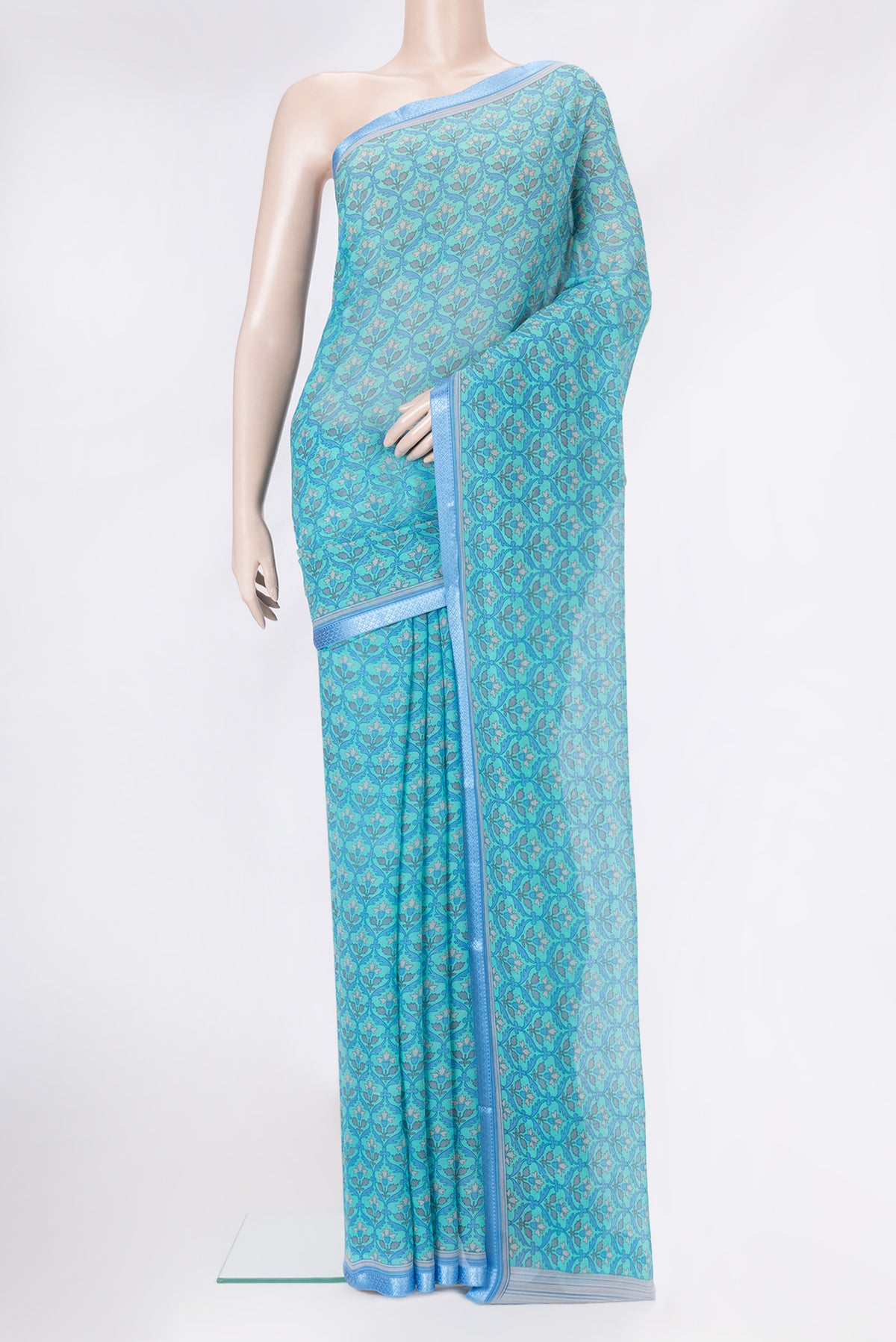 Sky Blue Mysore Chiffon Saree with Printed design on the body and Thread Border.  displayed on a mannequin