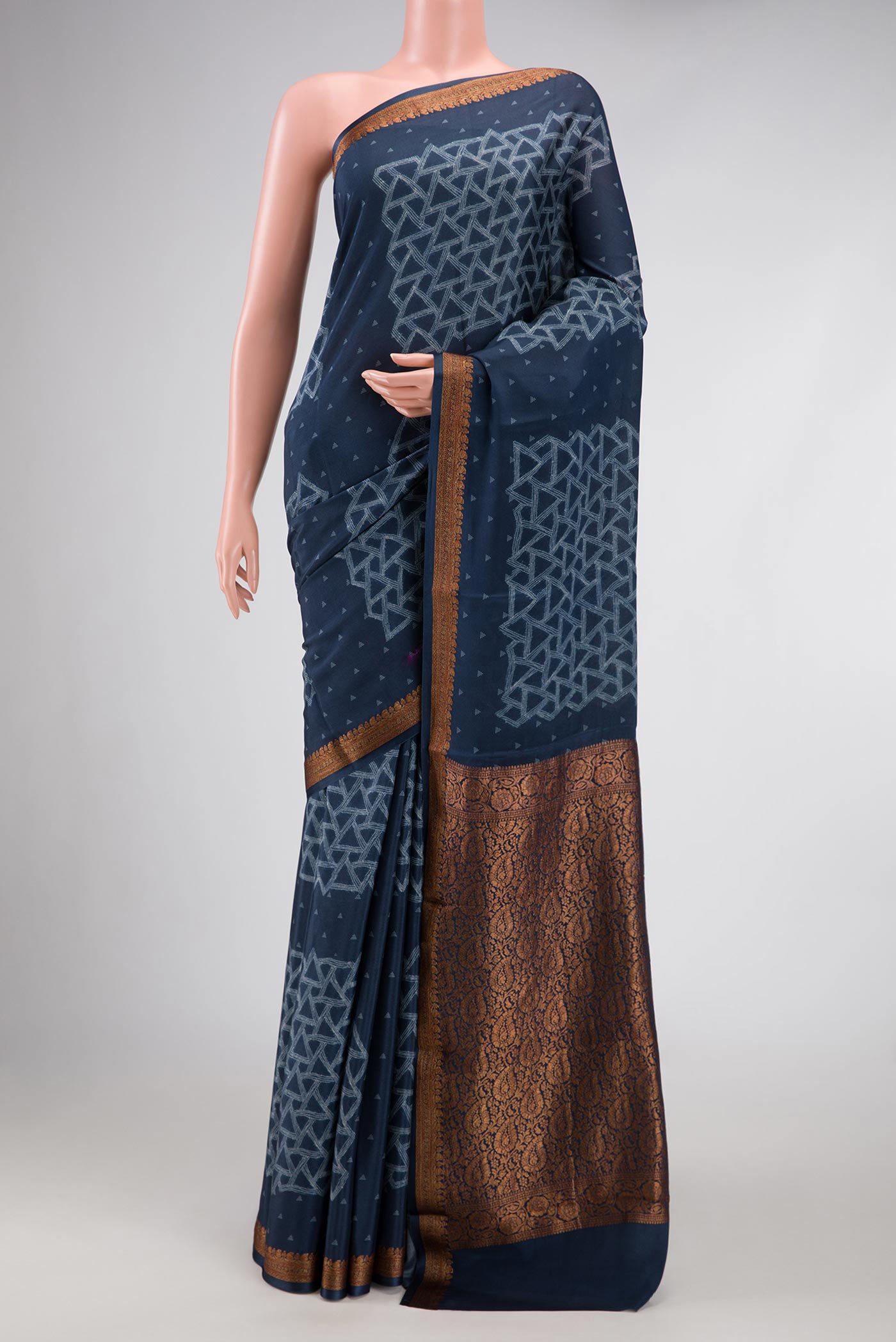Navy Blue Dual Tone Mysore Crepe Saree with Printed design on the body and Zari Border.  displayed on a mannequin