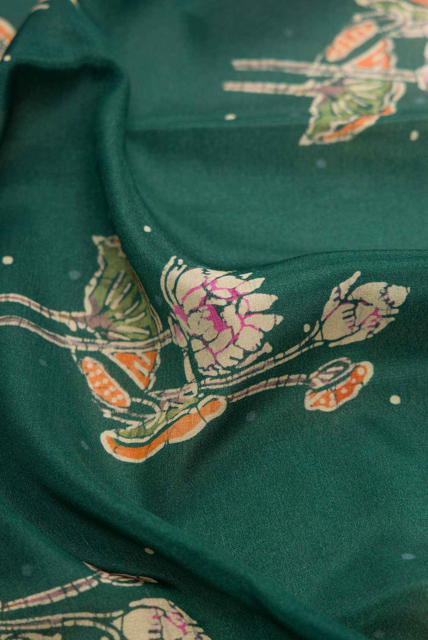 Close up of Bottle Green Dual Tone Mysore Crepe Saree with Printed design on the body and Thread Border.  displaying folds