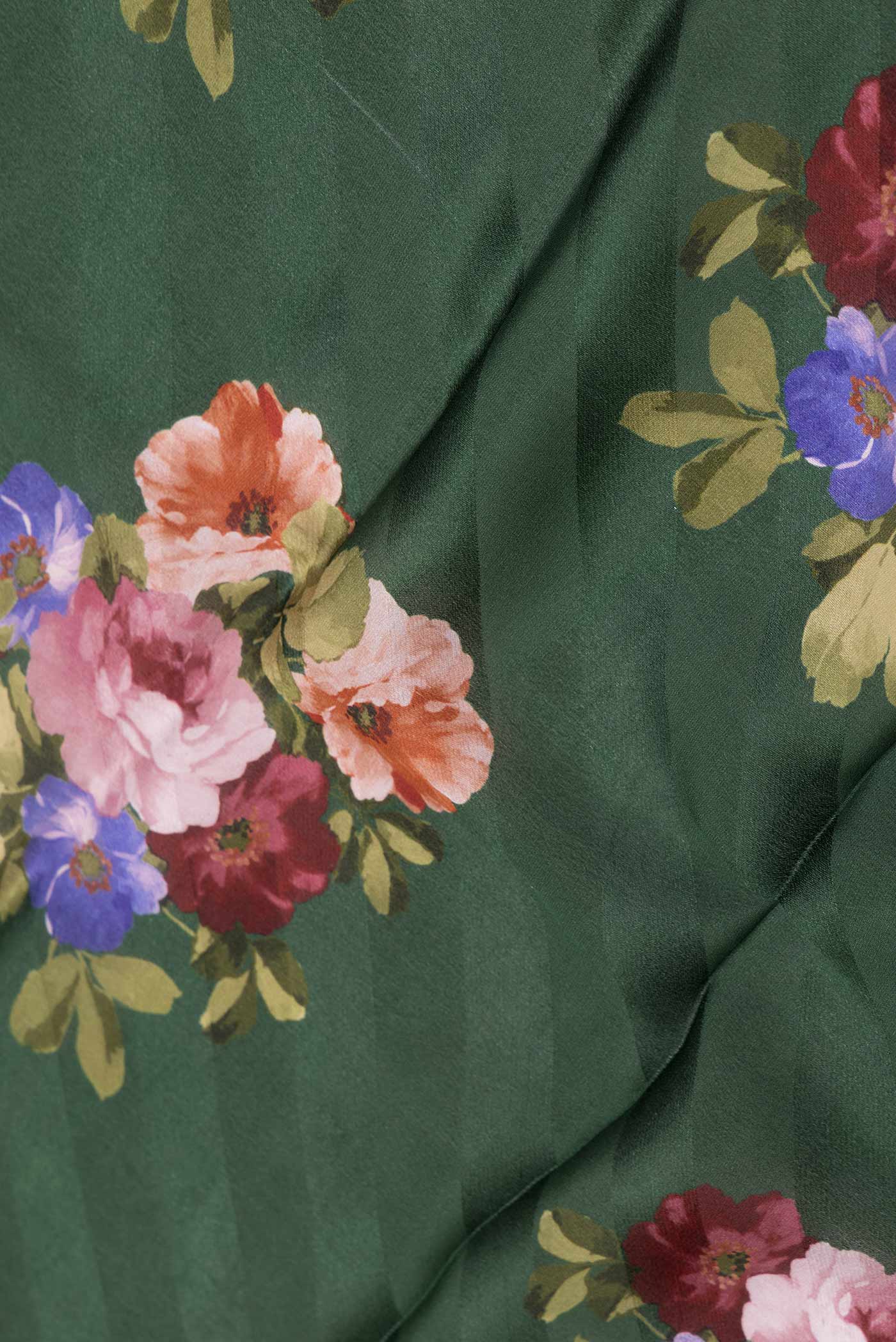 Close up of Green Dual Tone Mysore Crepe Saree with Printed design on the body and Zari Border displaying folds