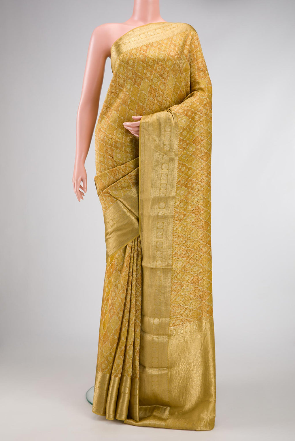 Mehandi Green Dual Tone Mysore Crepe Saree with Printed design on the body and Zari Border.  displayed on a mannequin