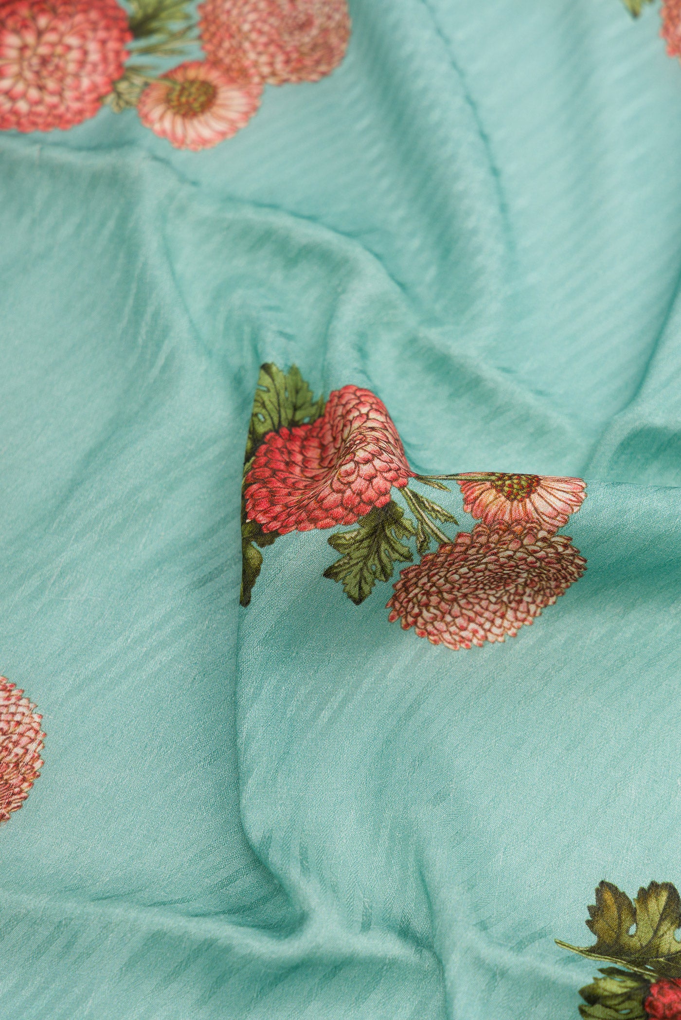 Close up of Light Blue Dual Tone Tussar Silk Saree with Printed design on the body and Zari Border.  displaying folds