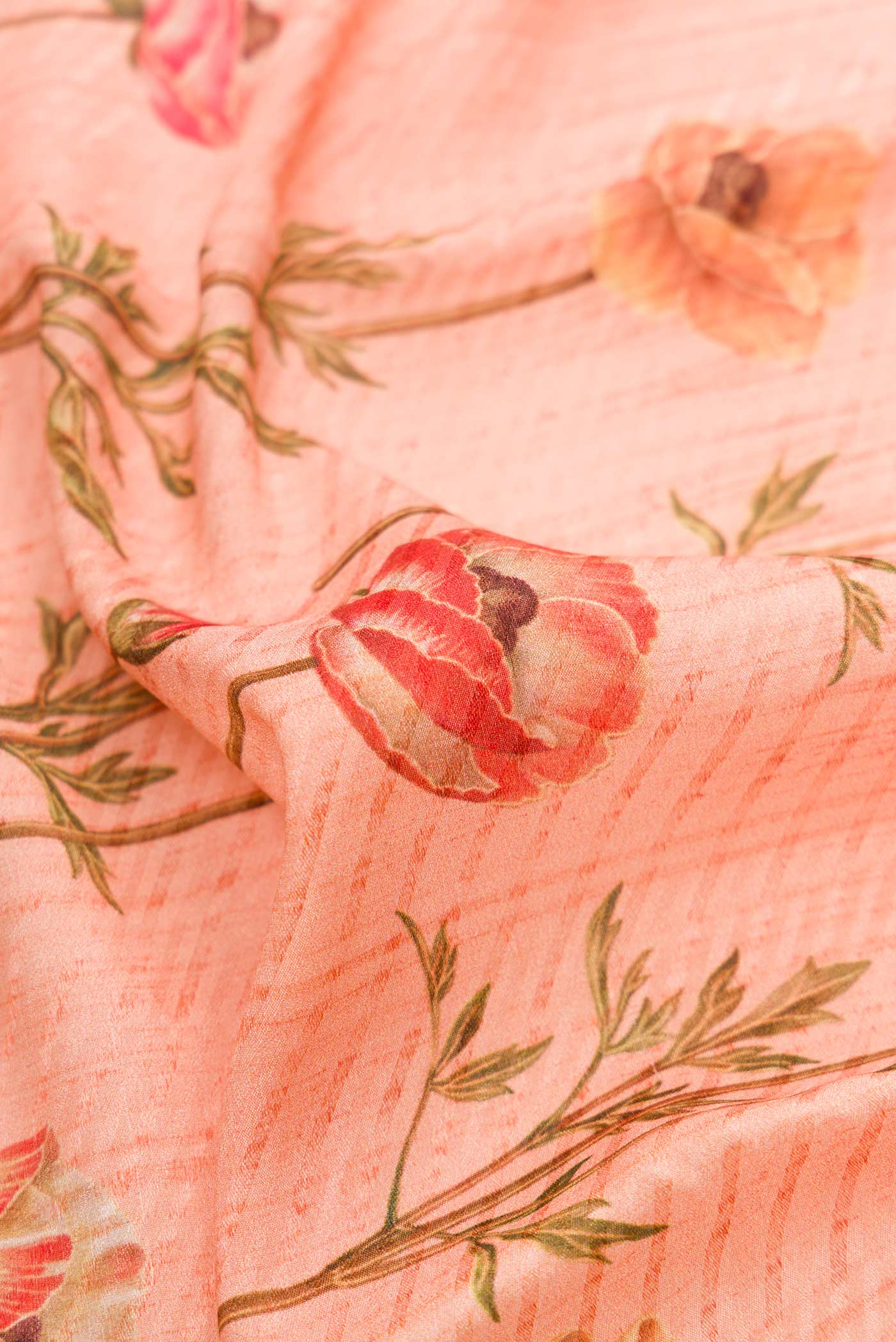 Close up of Golden Peach Dual Tone Mysore Crepe Saree with Printed design on the body and Zari Border.  displaying folds