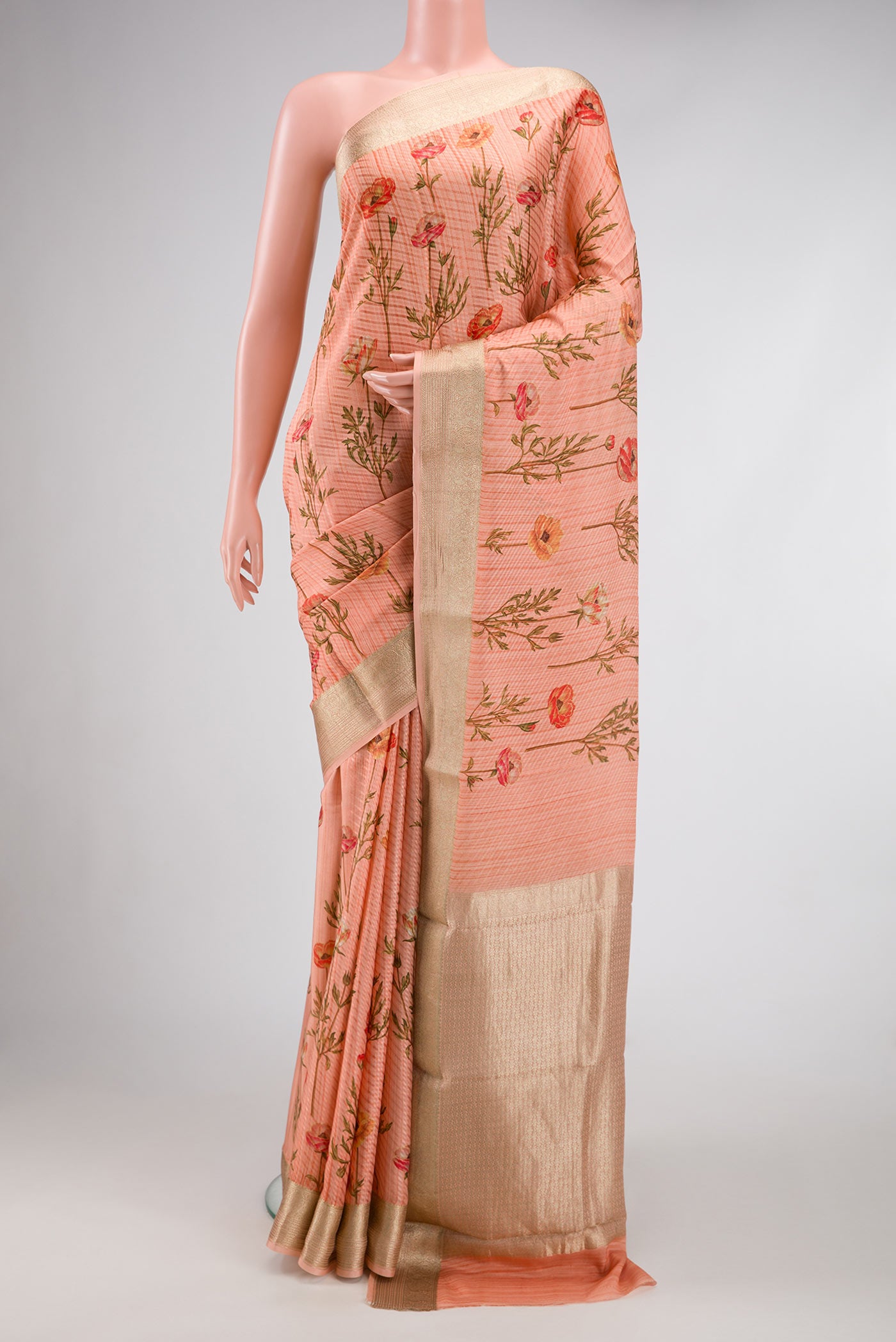 Golden Peach Dual Tone Mysore Crepe Saree with Printed design on the body and Zari Border.  displayed on a mannequin