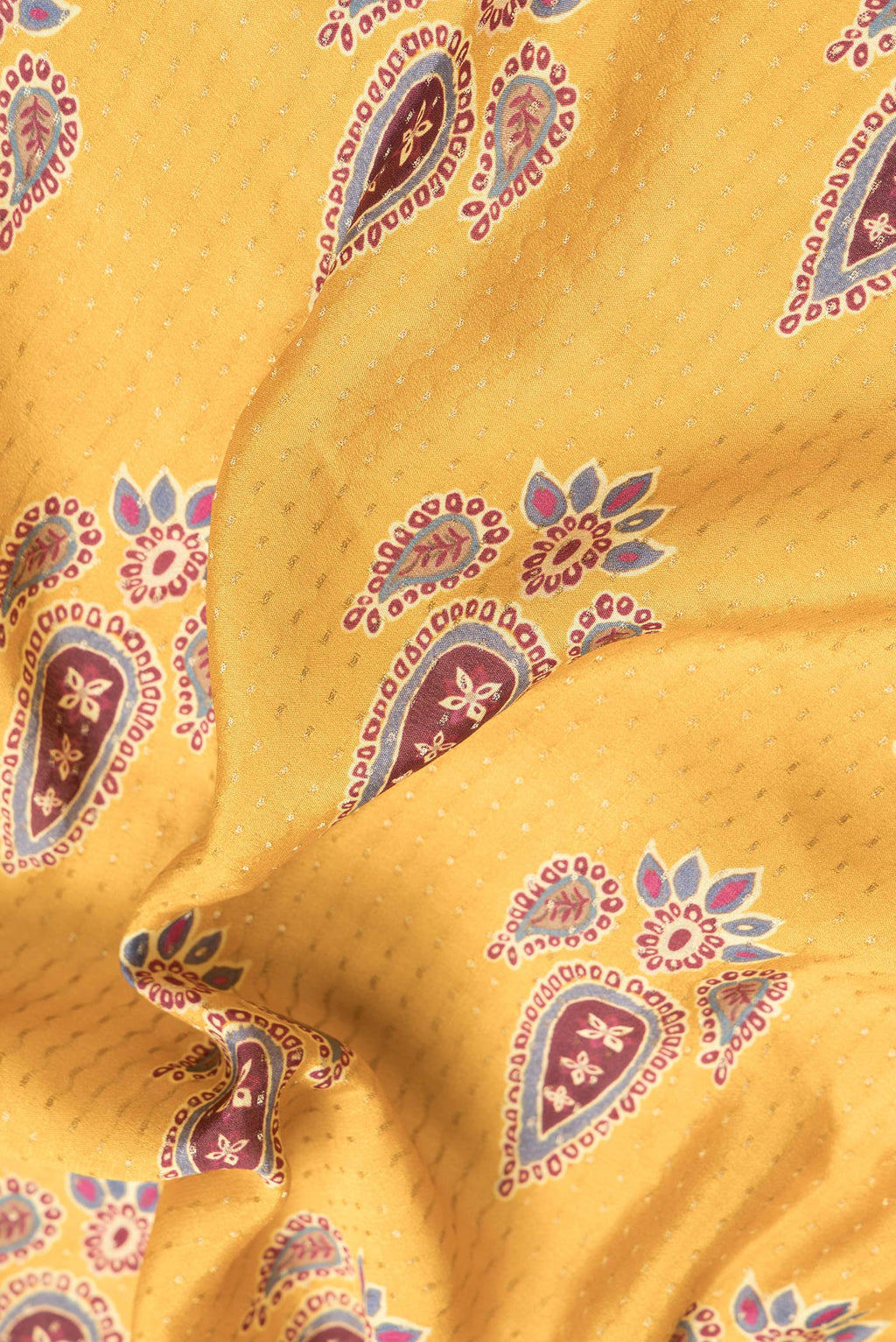 Close up of Mustard Dual Tone Mysore Crepe Saree with Printed design on the body and Zari Border.  displaying folds