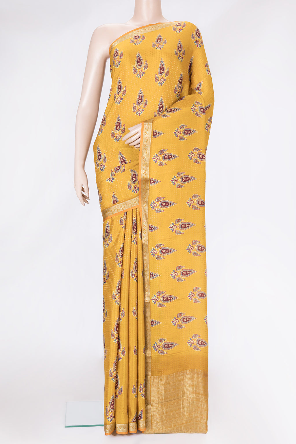 Mustard Dual Tone Mysore Crepe Saree with Printed design on the body and Zari Border.  displayed on a mannequin