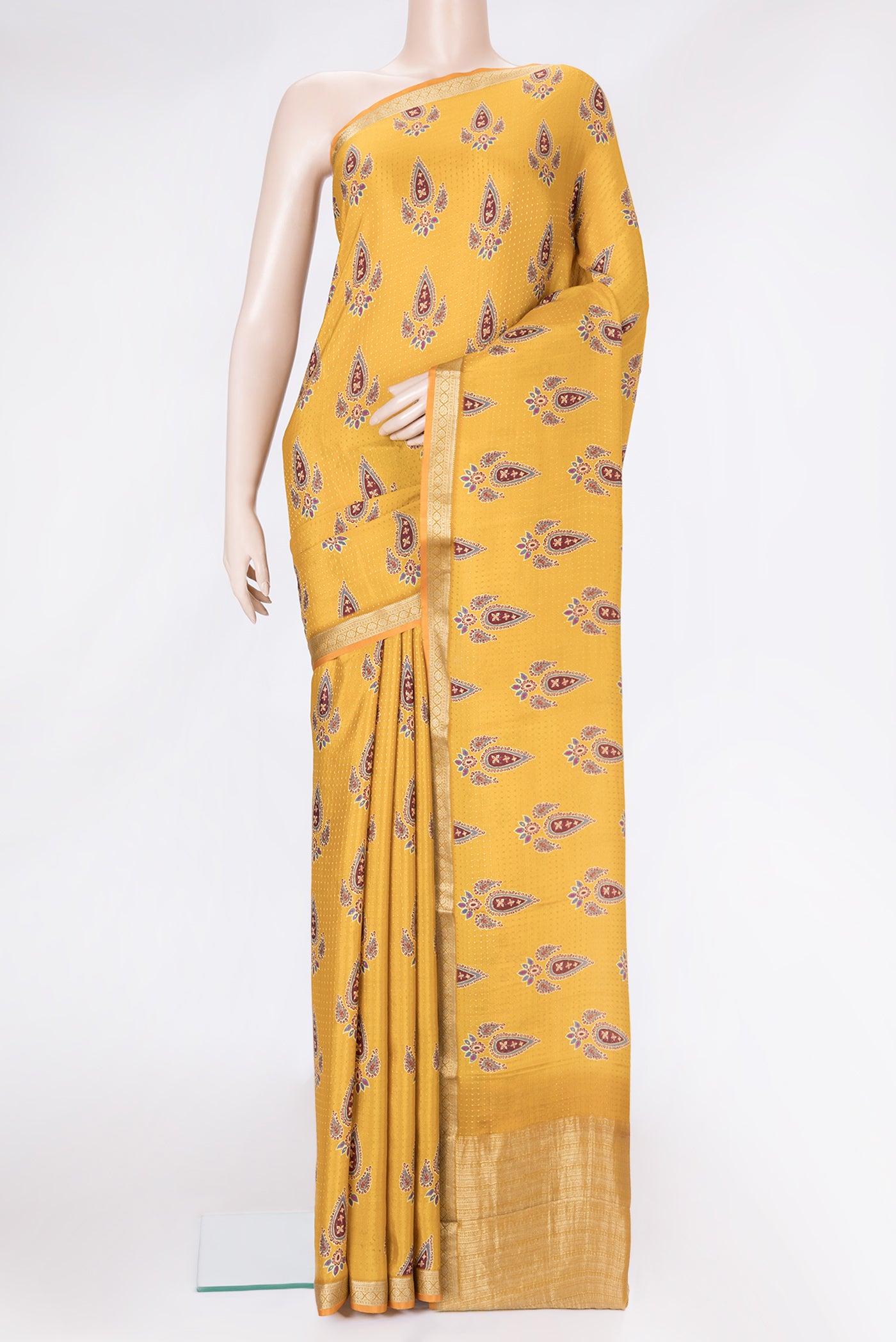 Mustard Dual Tone Mysore Crepe Saree with Printed design on the body and Zari Border.  displayed on a mannequin