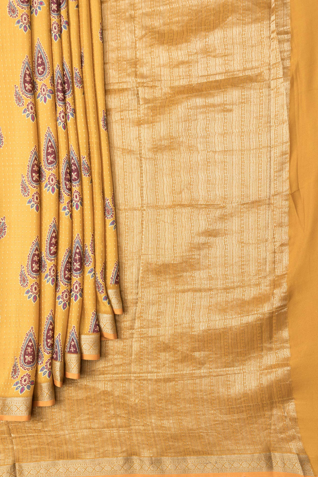 Pleats and pallu of Mustard Dual Tone Mysore Crepe Saree with Printed design on the body and Zari Border. 