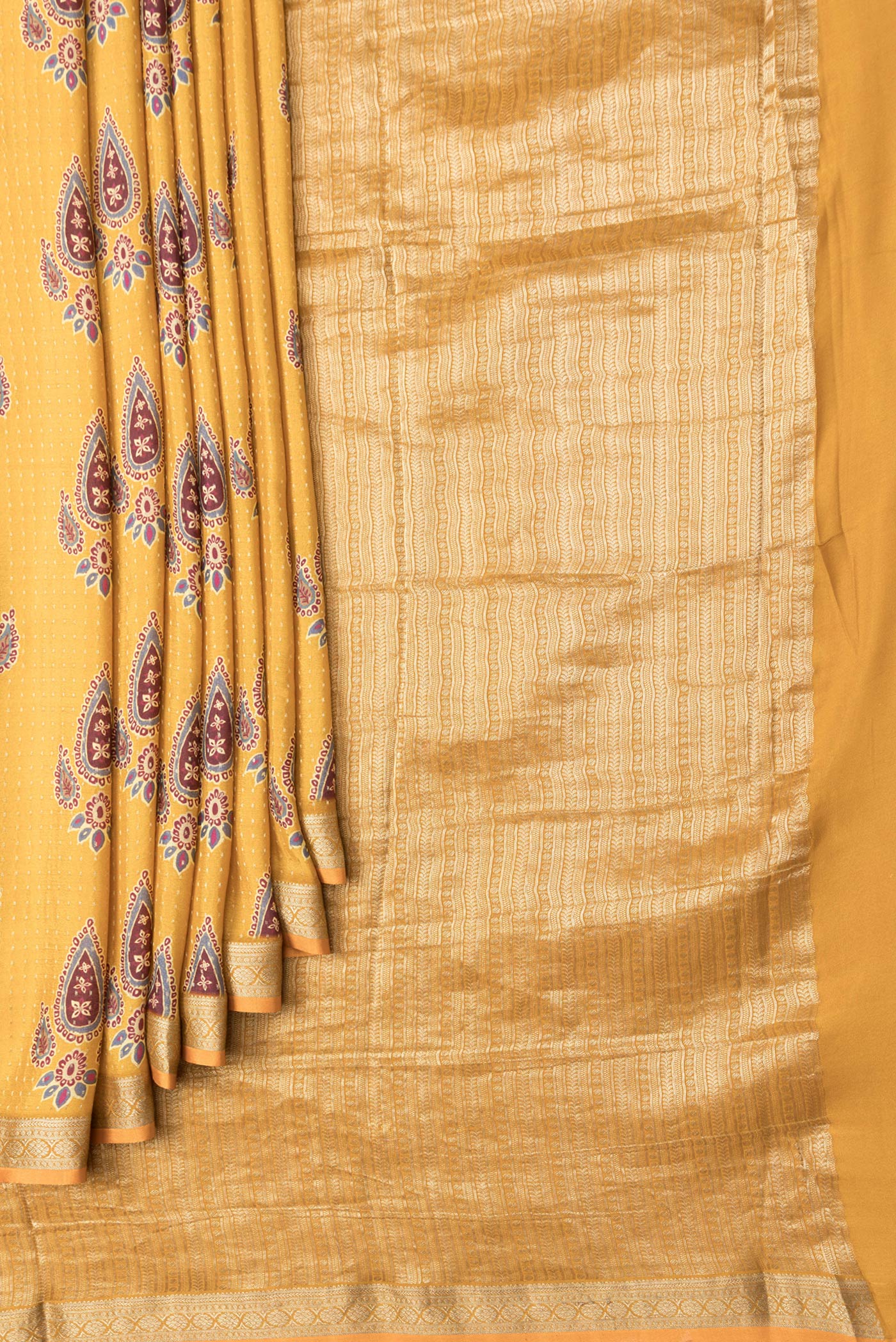 Pleats and pallu of Mustard Dual Tone Mysore Crepe Saree with Printed design on the body and Zari Border. 