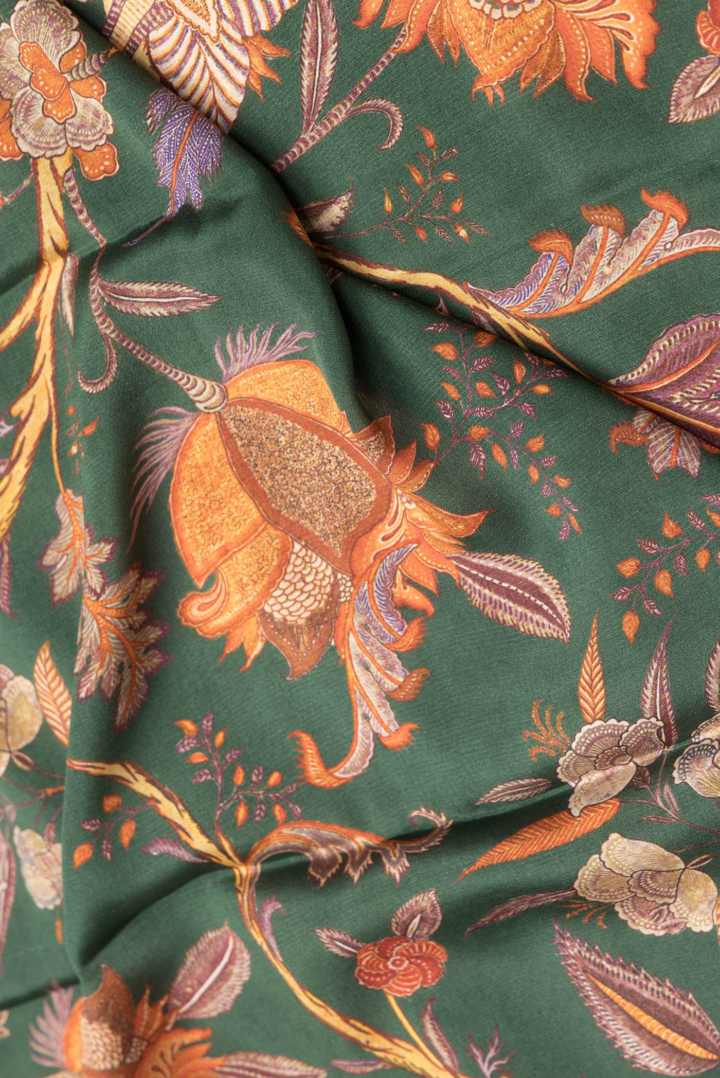 Close up of Bottle Green Dual Tone Mysore Crepe Saree with Printed design on the body and Zari Border.  displaying folds