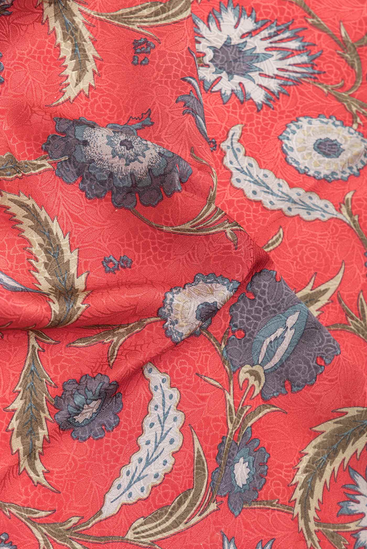 Close up of Orange Dual Tone Mysore Crepe Saree with Printed design on the body and Zari Border.  displaying folds